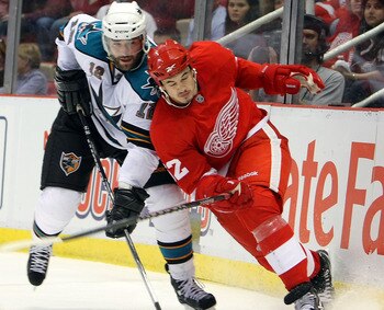 DETROIT - MAY 4:  Patrick Marleau #12 of the San Jose Sharks battles for position with Jonathan Ericsson #52 of the Detroit Red Wings in Game Three of the Western Conference Semifinals during the 2010 Stanley Cup Playoffs at Joe Louis Arena on May 4, 2010