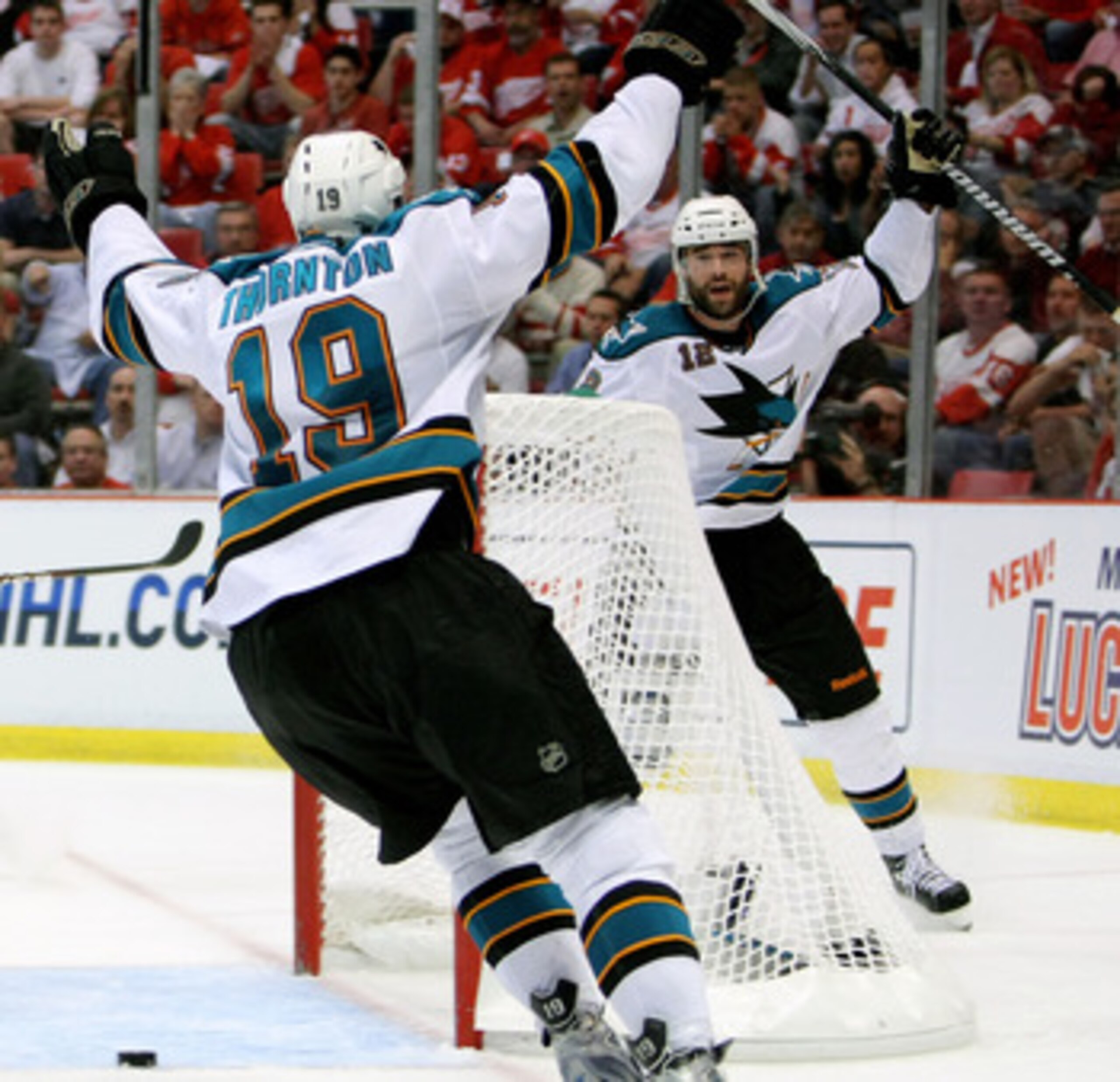 DETROIT - MAY 4:  Patrick Marleau #12 of the San Jose Sharks celebrates his overtime game-winning goal with teammate Joe Thornton #19 who assisted on the goal against the Detroit Red Wings in Game Three of the Western Conference Semifinals during the 2010