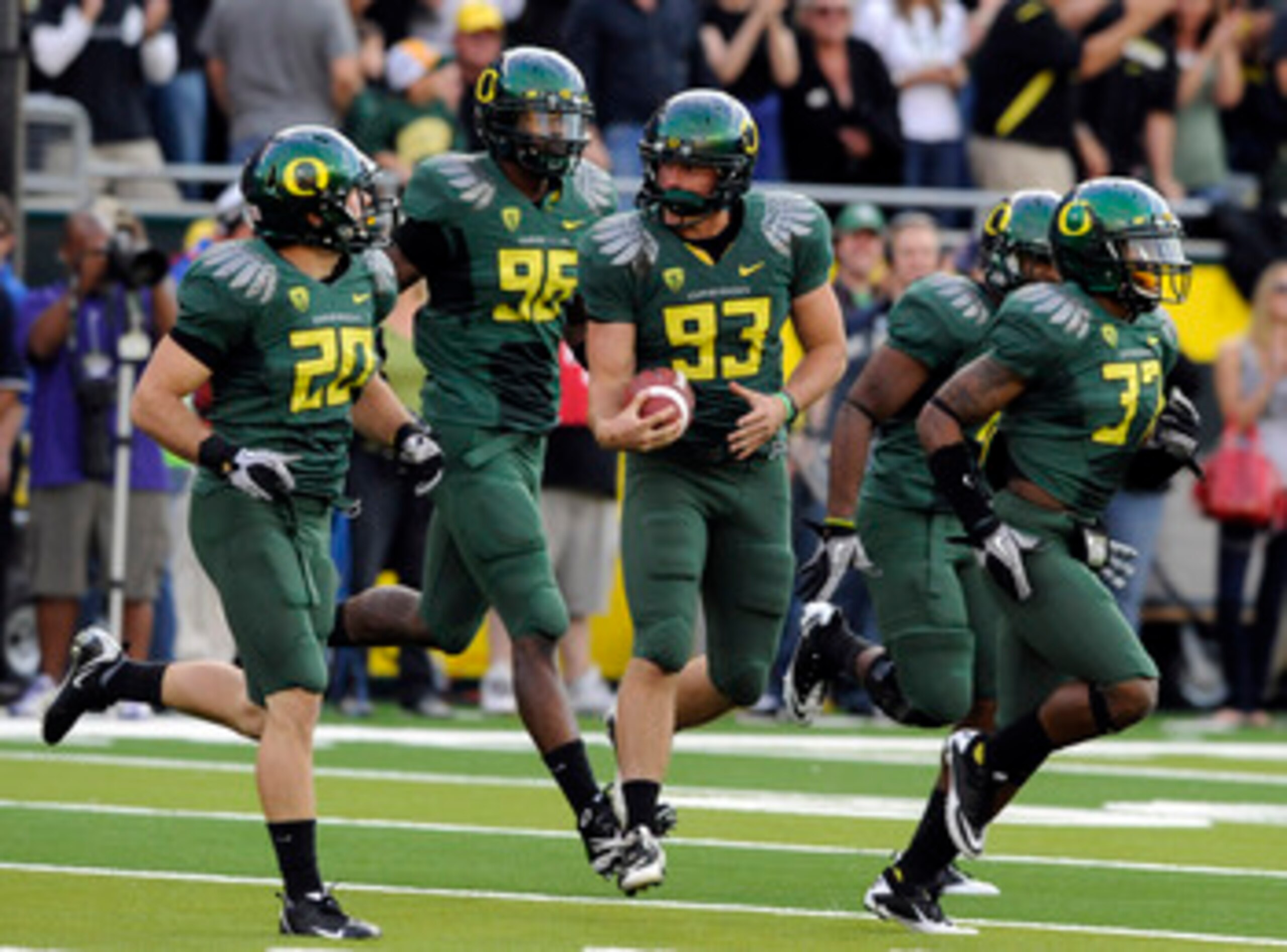 EUGENE, OR - OCTOBER 2: Kicker Rob Beard #93 runs off the field after recovering his own onside kick along with safety John Boyett #20,  defensive end Dion Jordan #96, and cornerback Talmadge Jackson III #37 of the Oregon Ducks in the second quarter of he