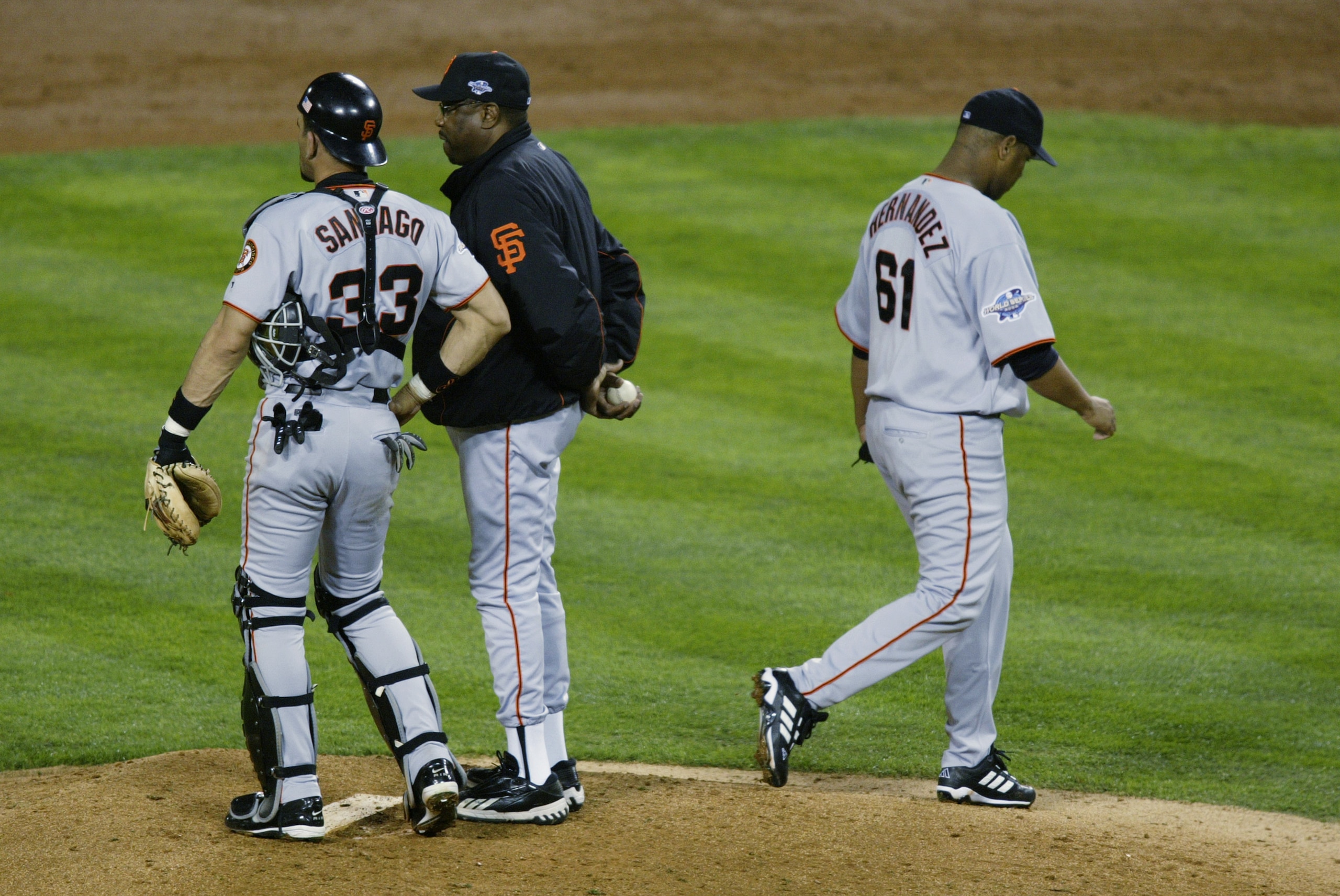 ANAHEIM, CA - OCTOBER 27:  Livan Hernandez #61 of the San Francisco Giants walks off the mound after being pulled as manager Dusty Baker and Benito Santiago #33 wait for new pitcher Chad Zerbe in the third inning of game seven of the World Series against 