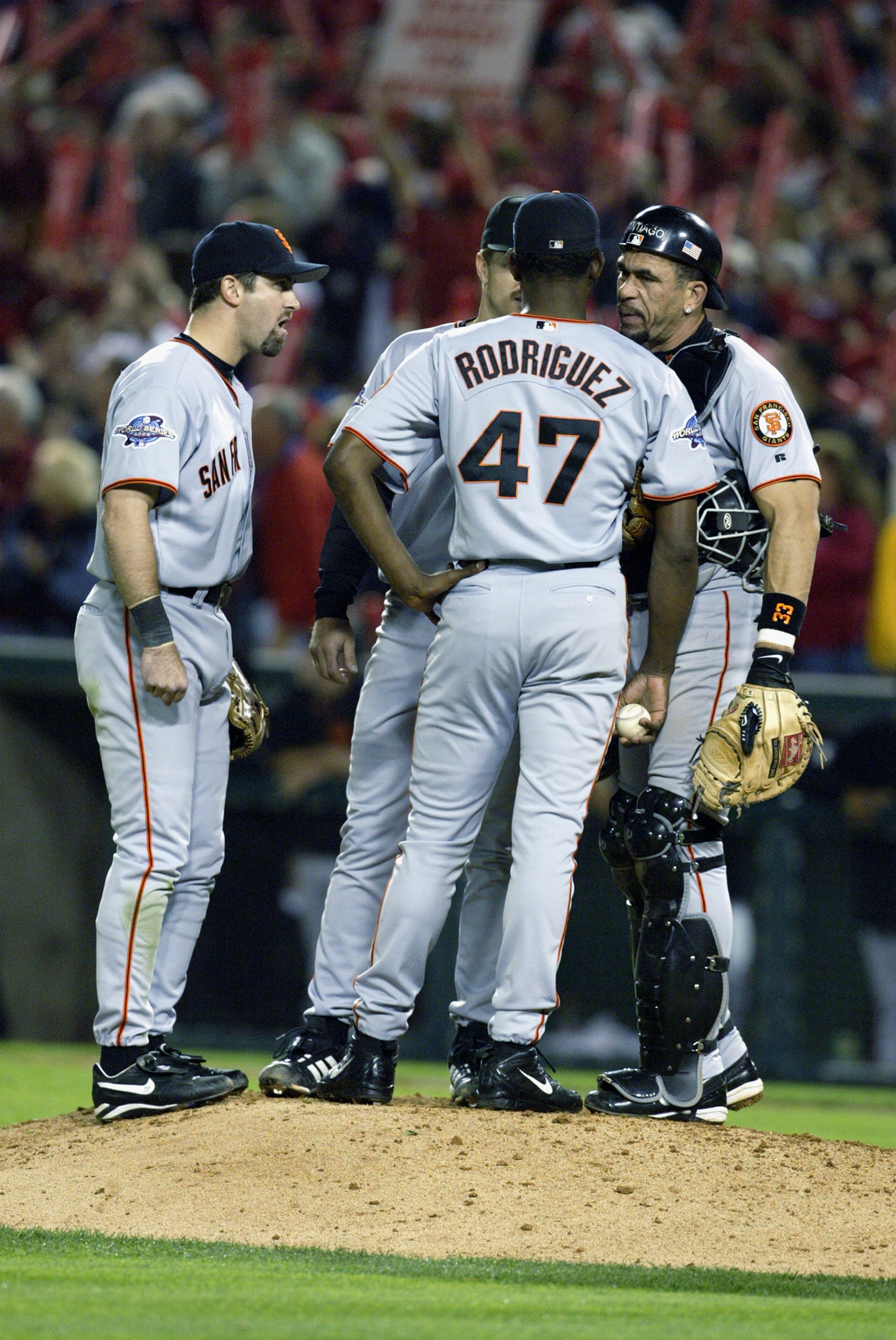 ANAHEIM, CA - OCTOBER 26:  (L-R) Shortstop Rich Aurilia #35, second baseman Jeff Kent #21, pitcher Felix Rodriguez #47 and catcher Benito Santiago #33 of the San Francisco Giants go over their options in Game six of the 2002 World Series against the Anahe