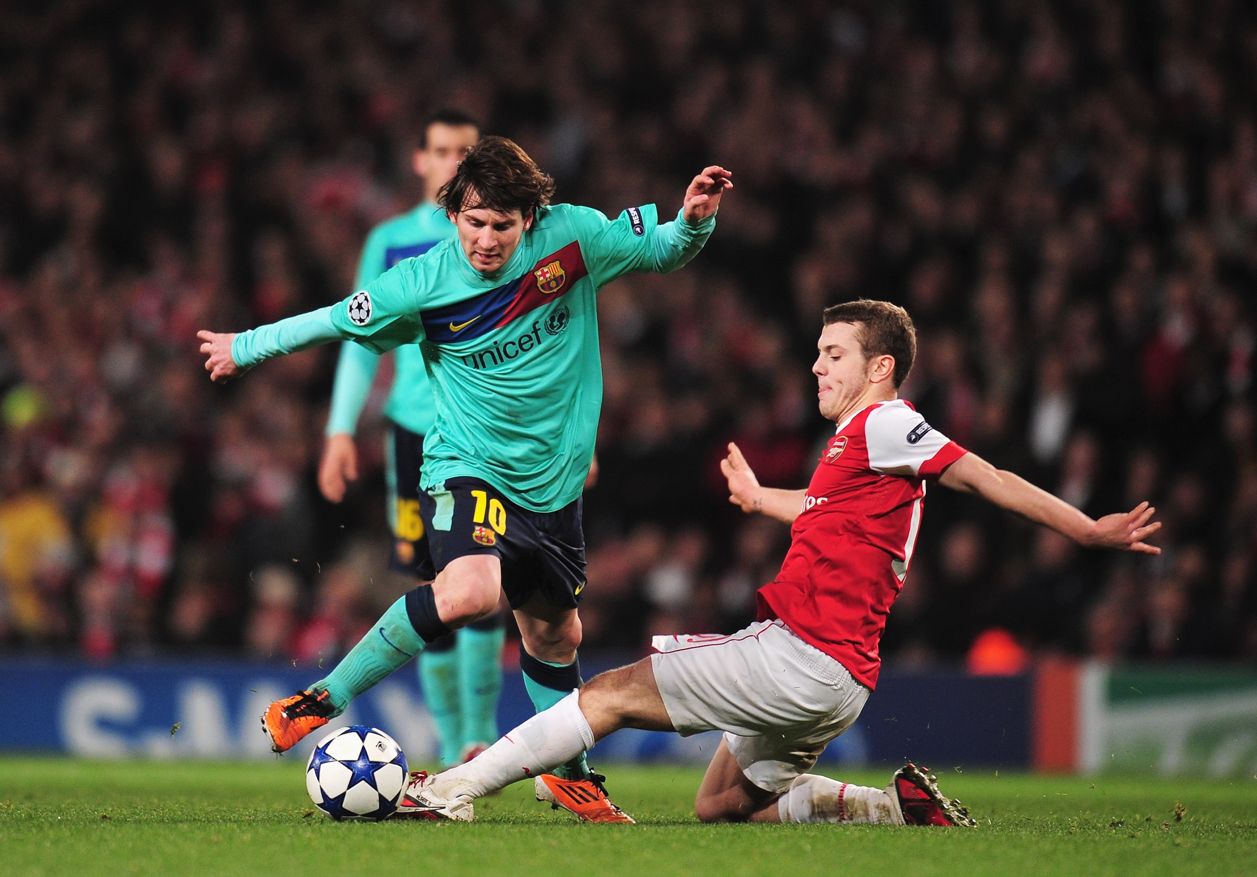 LONDON, ENGLAND - FEBRUARY 16: Lionel Messi of Barcelona is challenged by Jack Wilshere of Arsenal during the UEFA Champions League round of 16 first leg match between Arsenal and Barcelona at the Emirates Stadium on February 16, 2011 in London, Englan LONDON, ENGLAND - FEBRUARY 16: Lionel Messi of Barcelona is challenged by Jack Wilshere of Arsenal during the UEFA Champions League round of 16 first leg match between Arsenal and Barcelona at the Emirates Stadium on February 16, 2011 in London, Englan