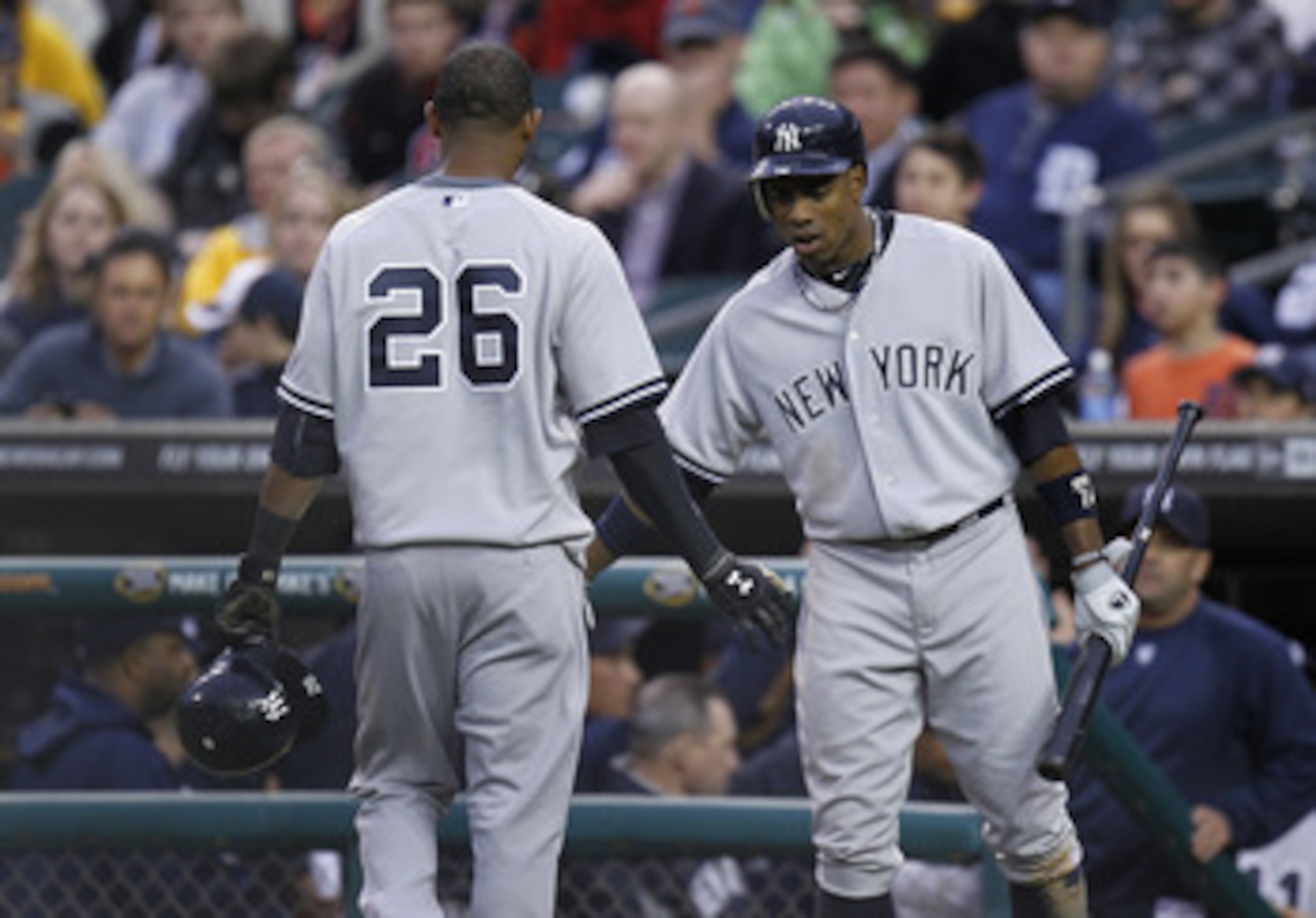 DETROIT, MI - MAY 02: Curtis Granderson #14 of the New York Yankees congratulates Eduardo Nunez after driving in a run in the second inning while playing the New York Yankees at Comerica Park on May 2, 2011 in Detroit, Michigan. New York won the game 5-3.