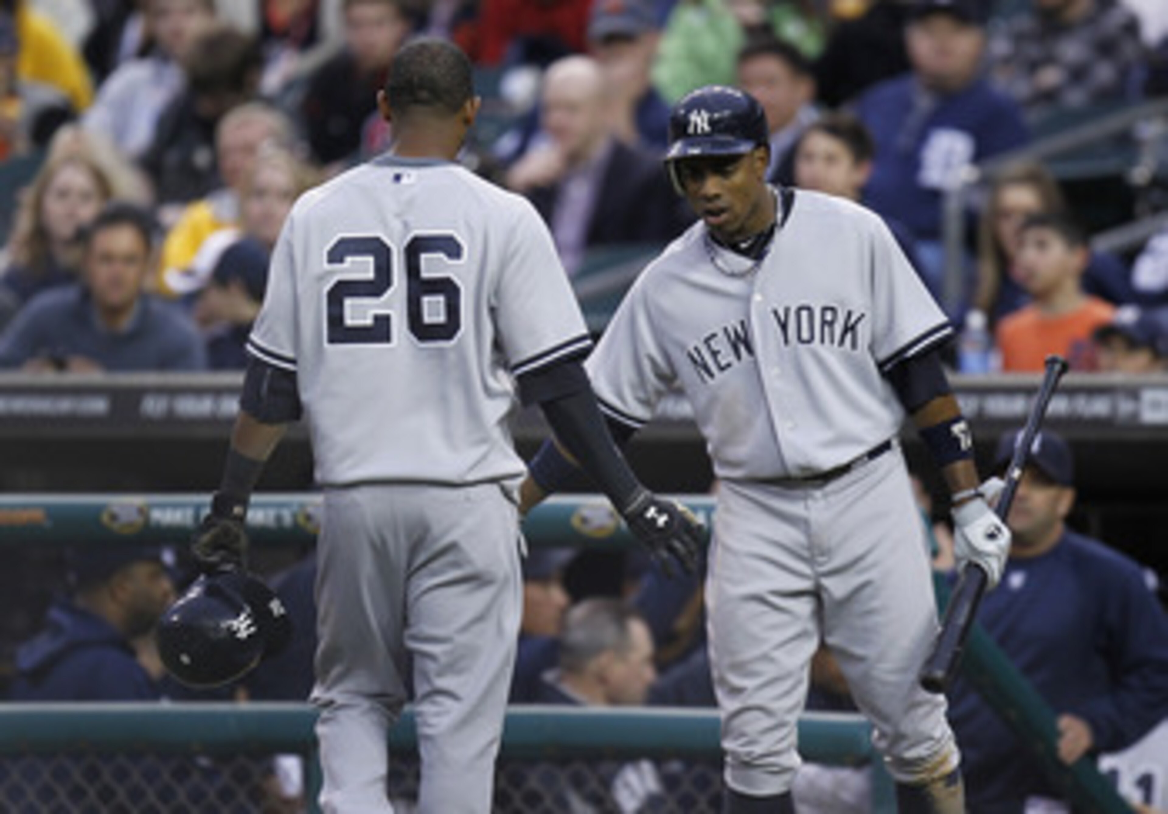 DETROIT, MI - MAY 02: Curtis Granderson #14 of the New York Yankees congratulates Eduardo Nunez after driving in a run in the second inning while playing the New York Yankees at Comerica Park on May 2, 2011 in Detroit, Michigan. New York won the game 5-3.