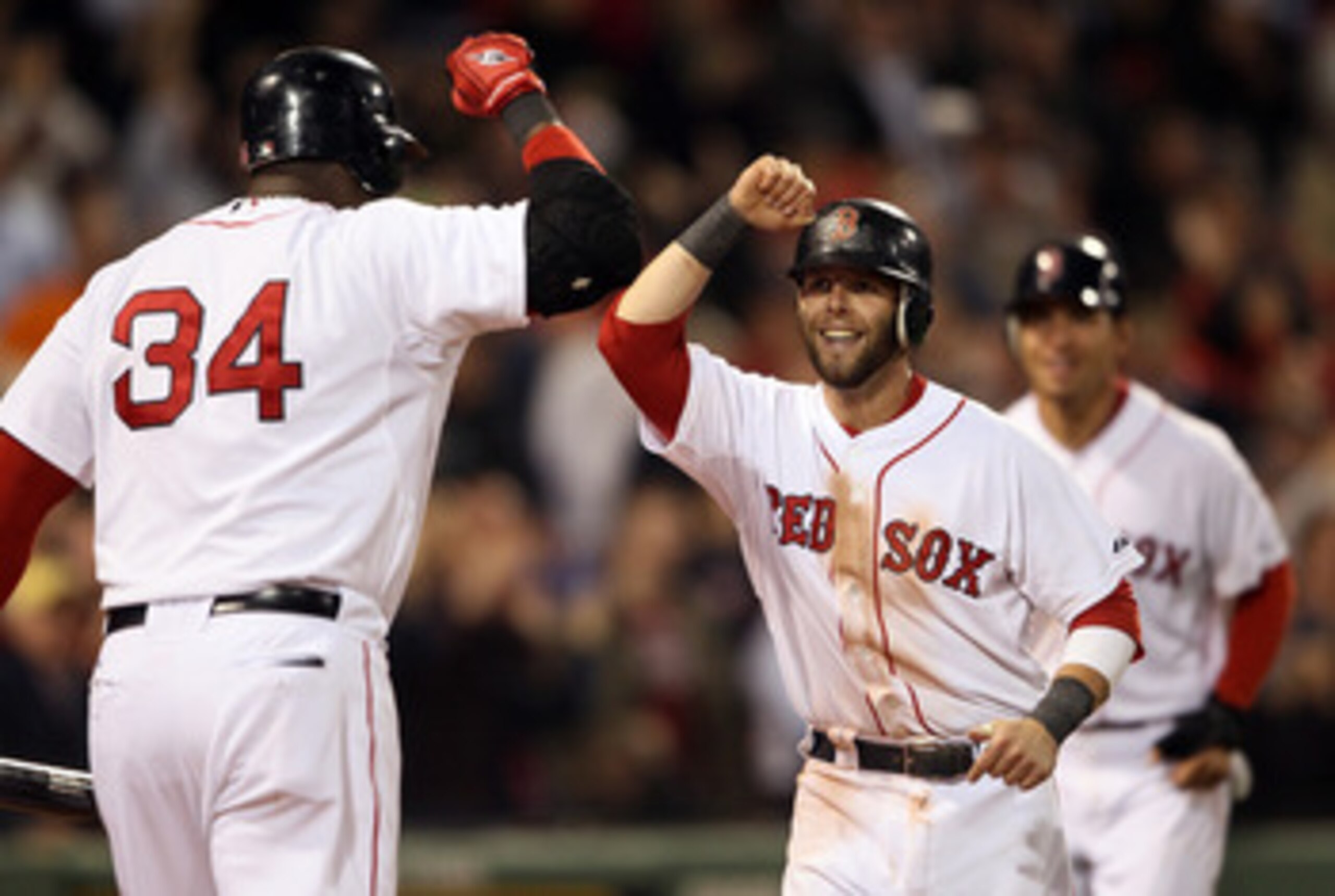 BOSTON, MA - MAY 02:  Dustin Pedroia #15 of the Boston Red Sox is congratulated by teammate David Ortiz #34 after Pedroia and Jacoby Ellsbury scored on a hit by Adrian Gonzalez in the seventh inning against the Los Angeles Angels on May 2, 2011 at Fenway 