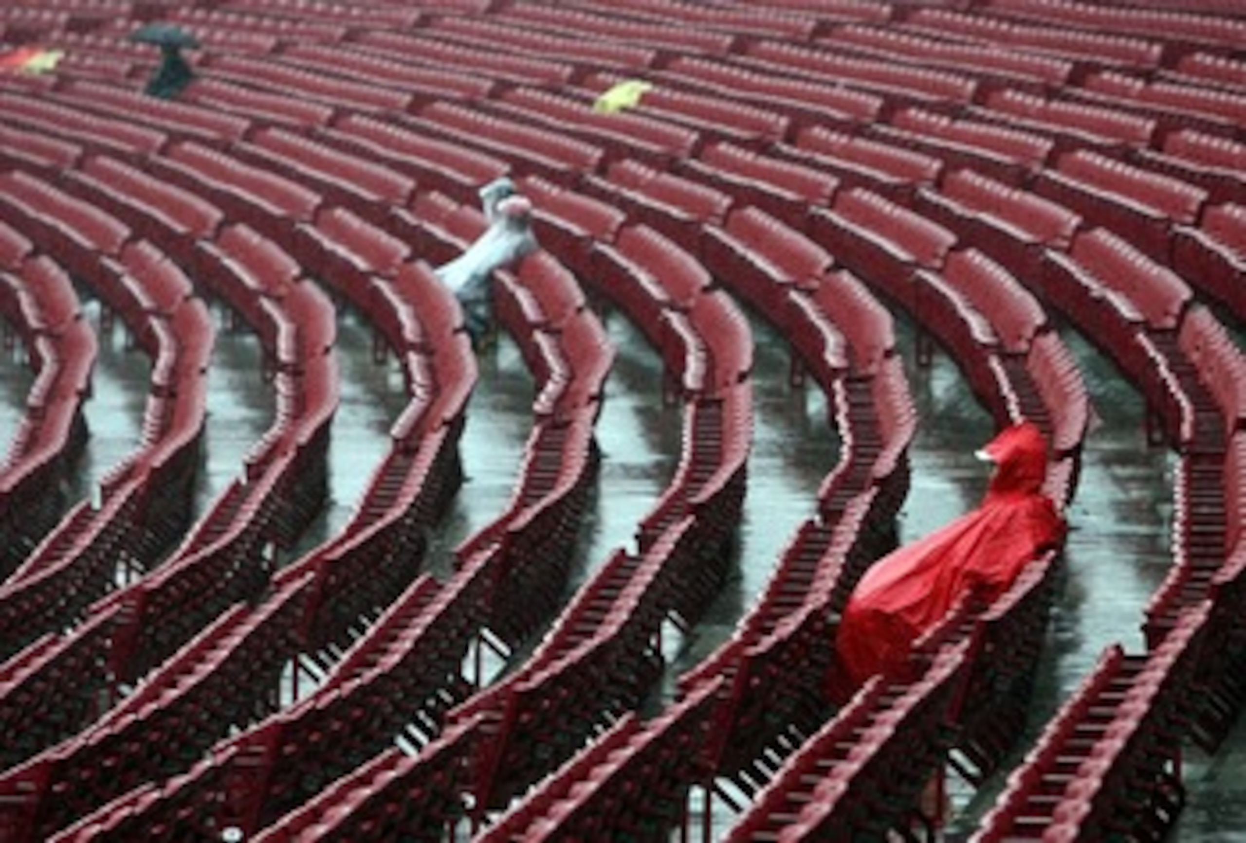 CINCINNATI - MARCH 31:  Fans sit through a steady rain before the game between the Cincinnati Reds and the Arizona Diamondbacks on March 31, 2008 at Great American Ball Park in Cincinnati, Ohio.  (Photo by Andy Lyons/Getty Images)