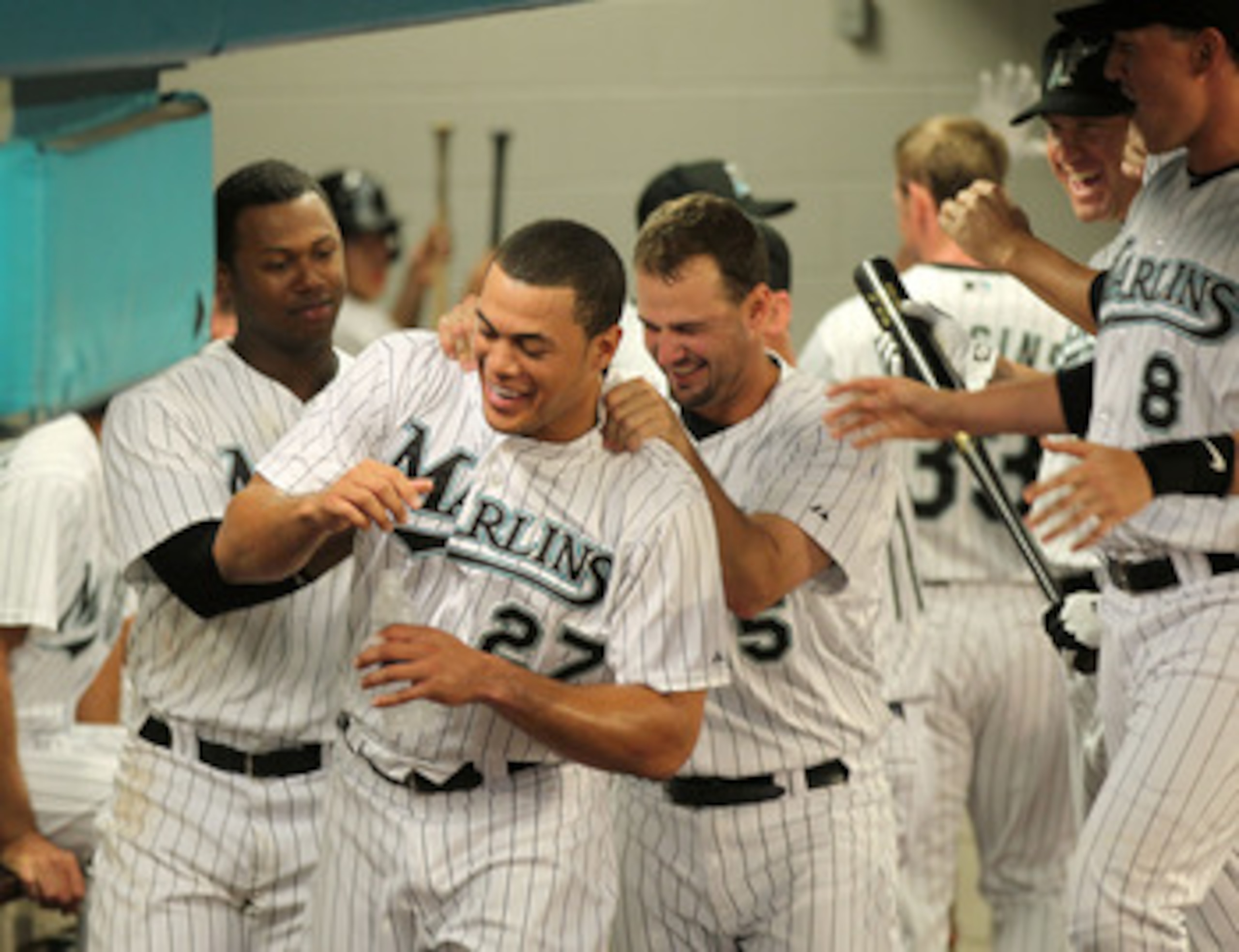 MIAMI GARDENS, FL - APRIL 21:  Mike Stanton #27 of the Florida Marlins is congratulated by Hanley Ramirez #2 and Gaby Sanchez #15 after hitting  his first home run of the year during a game against the Pittsburgh Pirates at Sun Life Stadium on April 21, 2