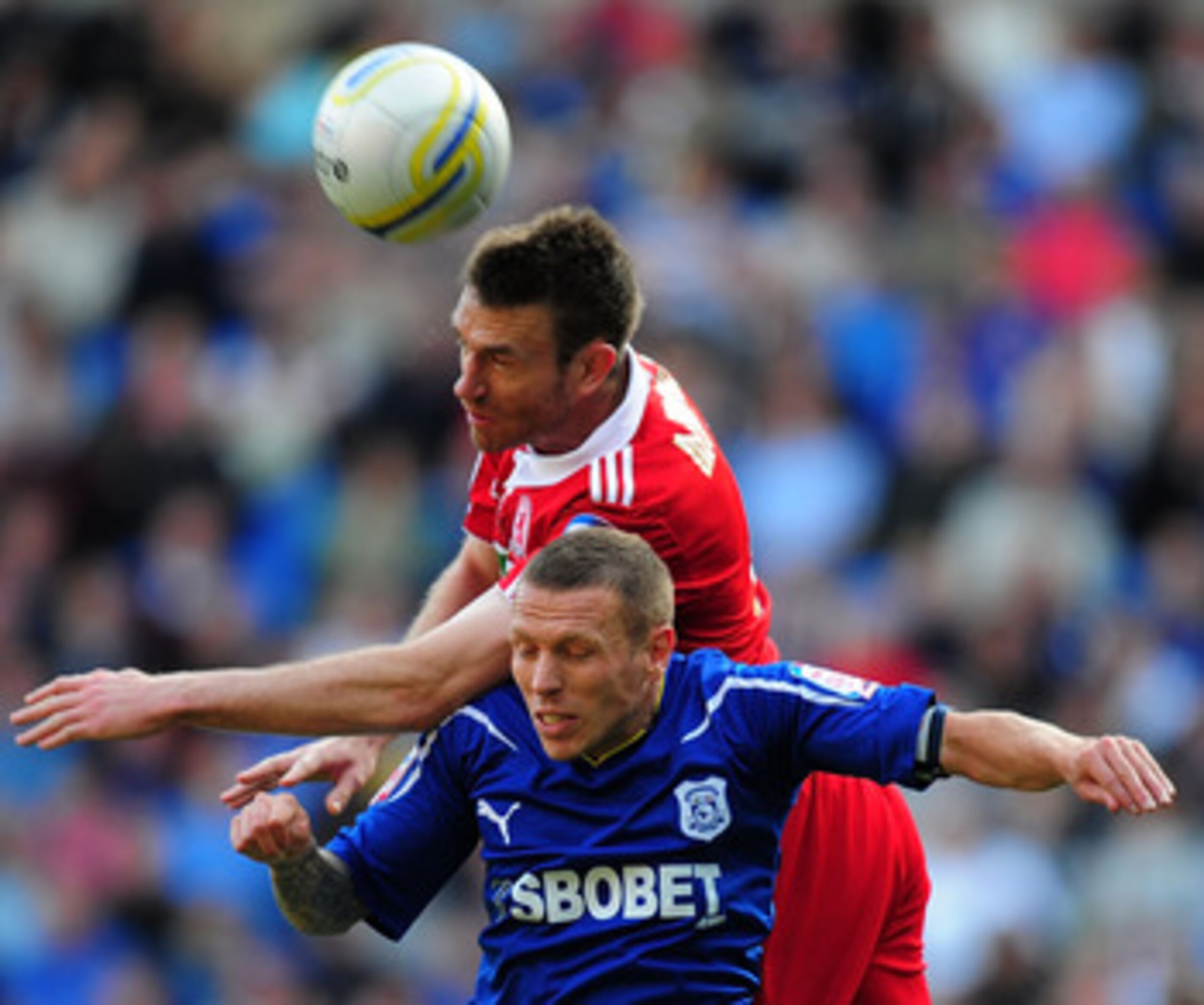 CARDIFF, WALES - MAY 02:  Cardiff player Craig Bellamy is beaten to the ball by Middlesbrough player Stephen Mcmanus during the npower Championship game between Cardiff City and Middlesbrough at Cardiff City Stadium on May 2, 2011 in Cardiff, Wales.  (Pho