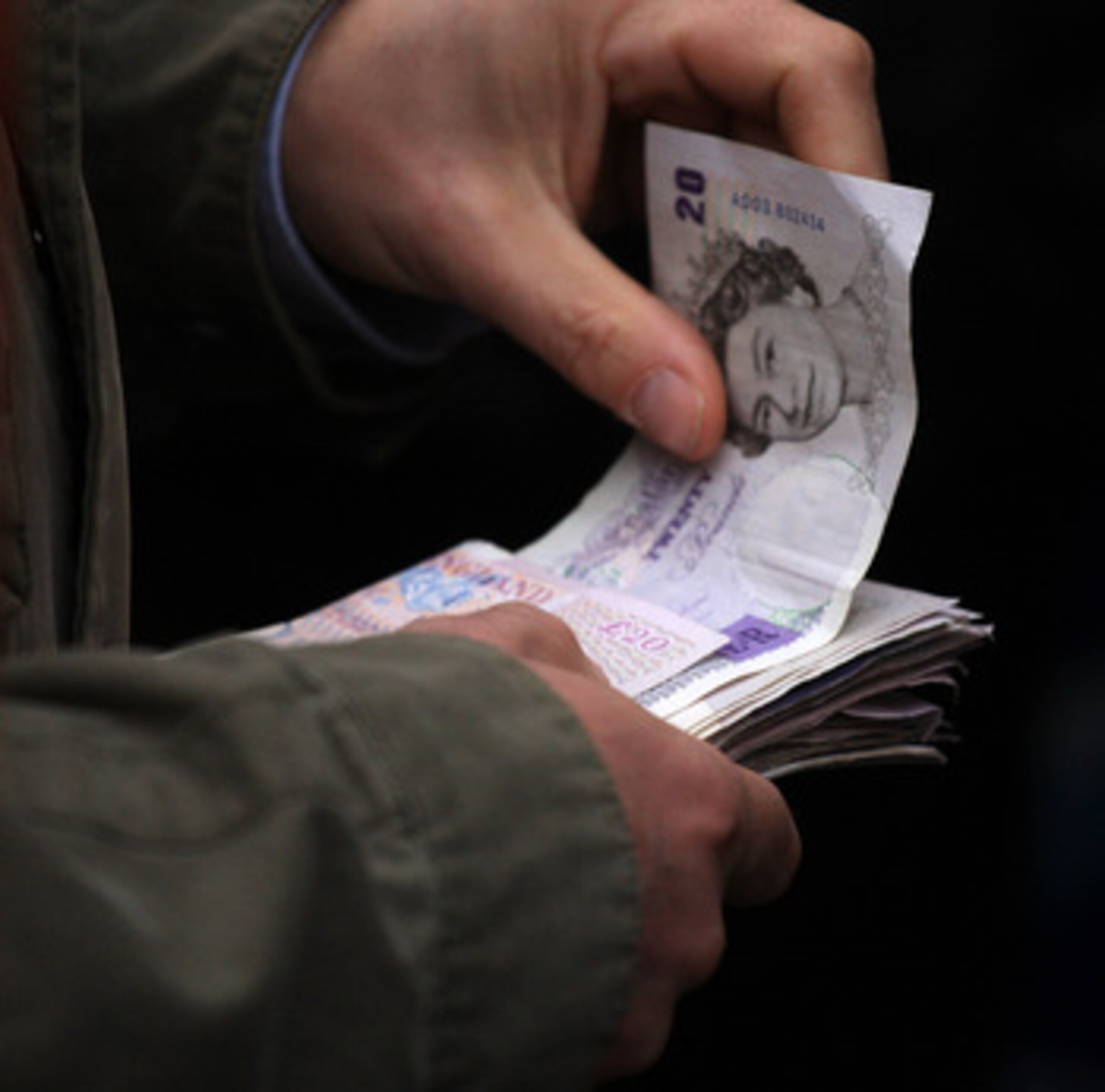 CHELTENHAM, ENGLAND - MARCH 14:  A punter hands over money for a bet at Cheltenham Racecourse on March 14, 2008, in Cheltenham, England. Today was the fourth day of The Annual National Hunt Festival held at the Gloucestershire track.  (Photo by Julian Her