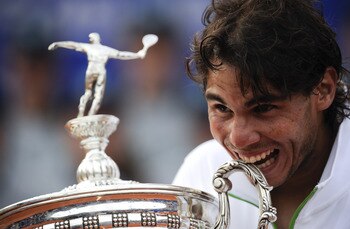 BARCELONA, SPAIN - APRIL 24:  Rafael Nadal of Spain bites the trophy after beating David Ferrer during the final match on day seven of the ATP 500 World Tour Barcelona Open Banco Sabadell 2011 tennis tournament at the Real Club de Tenis on April 24, 2011