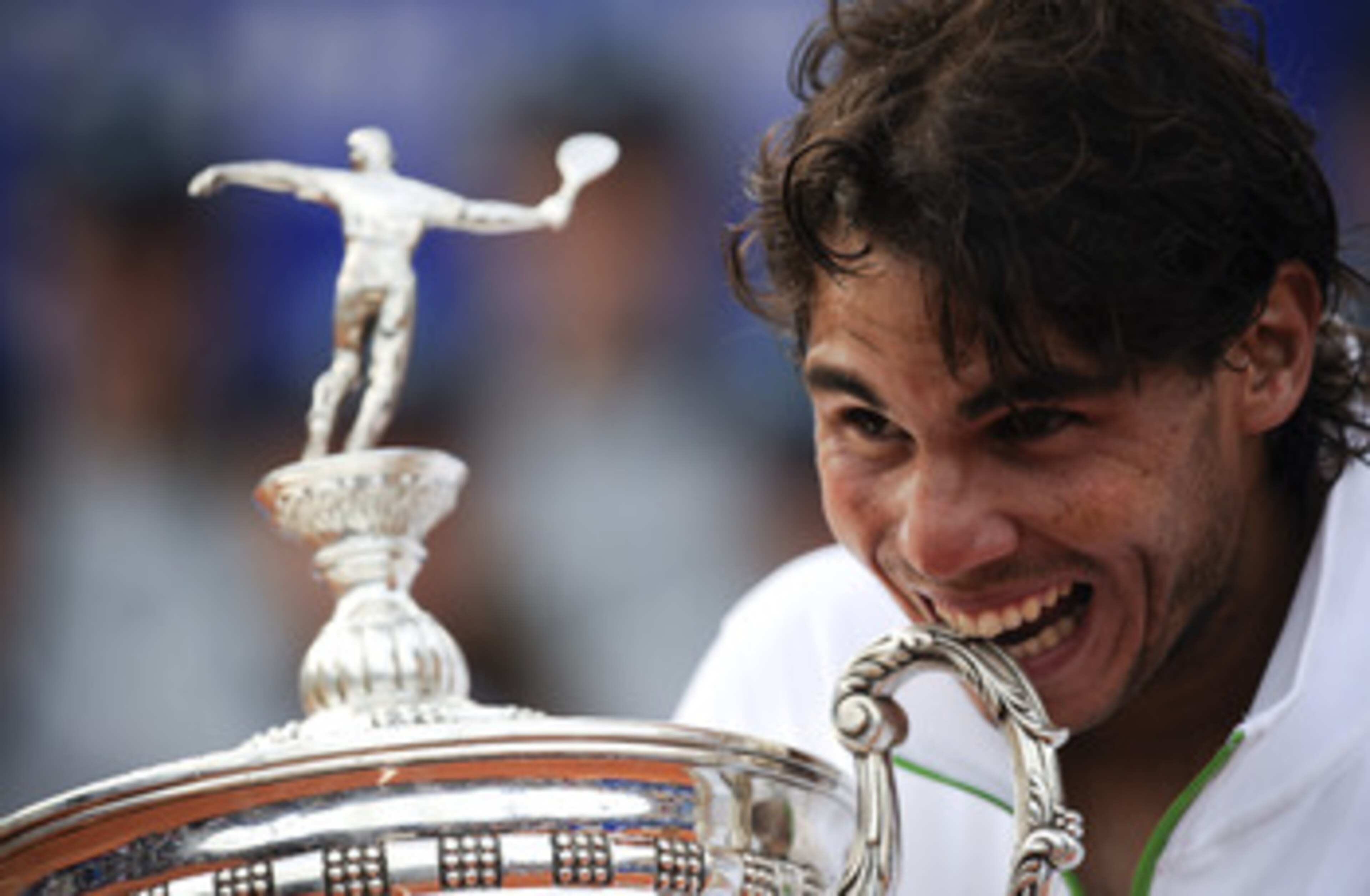 BARCELONA, SPAIN - APRIL 24: Rafael Nadal of Spain bites the trophy after beating David Ferrer during the final match on day seven of the ATP 500 World Tour Barcelona Open Banco Sabadell 2011 tennis tournament at the Real Club de Tenis on April 24, 2011 BARCELONA, SPAIN - APRIL 24: Rafael Nadal of Spain bites the trophy after beating David Ferrer during the final match on day seven of the ATP 500 World Tour Barcelona Open Banco Sabadell 2011 tennis tournament at the Real Club de Tenis on April 24, 2011