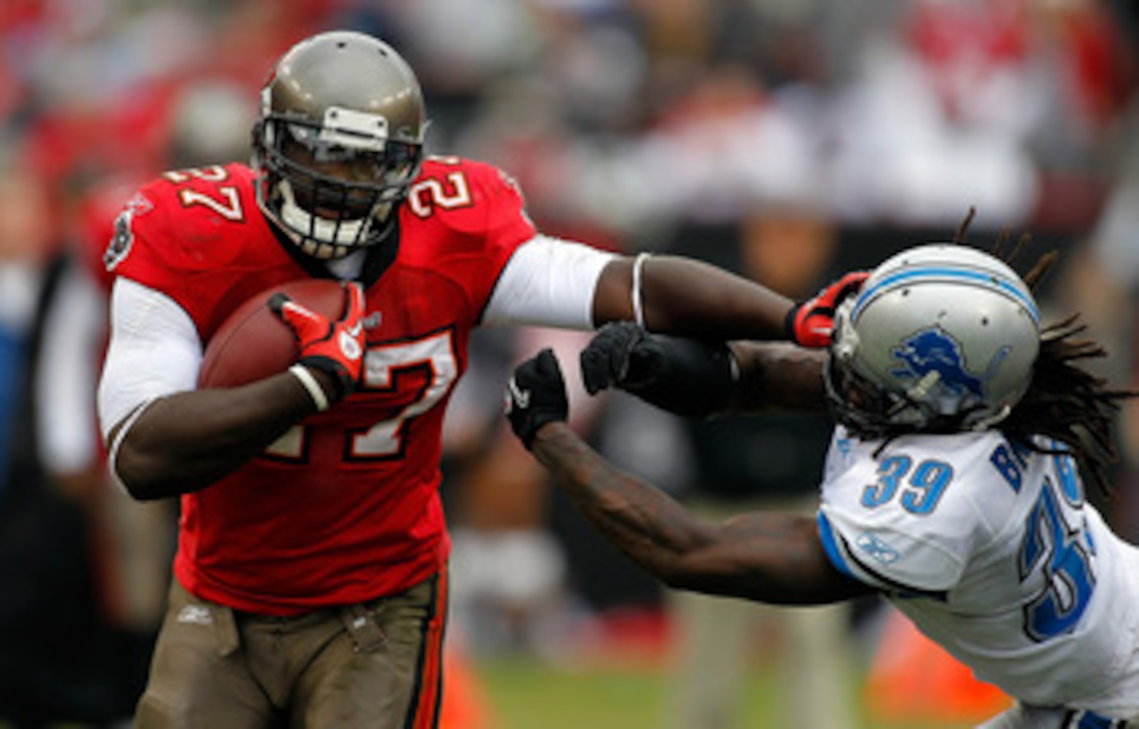 TAMPA, FL - DECEMBER 19:  Running back LeGarrette Blount #27 of the Tampa Bay Buccaneers straight-arms safety C.C. Brown #39 of the Detroit Lions during the game at Raymond James Stadium on December 19, 2010 in Tampa, Florida.  (Photo by J. Meric/Getty Im