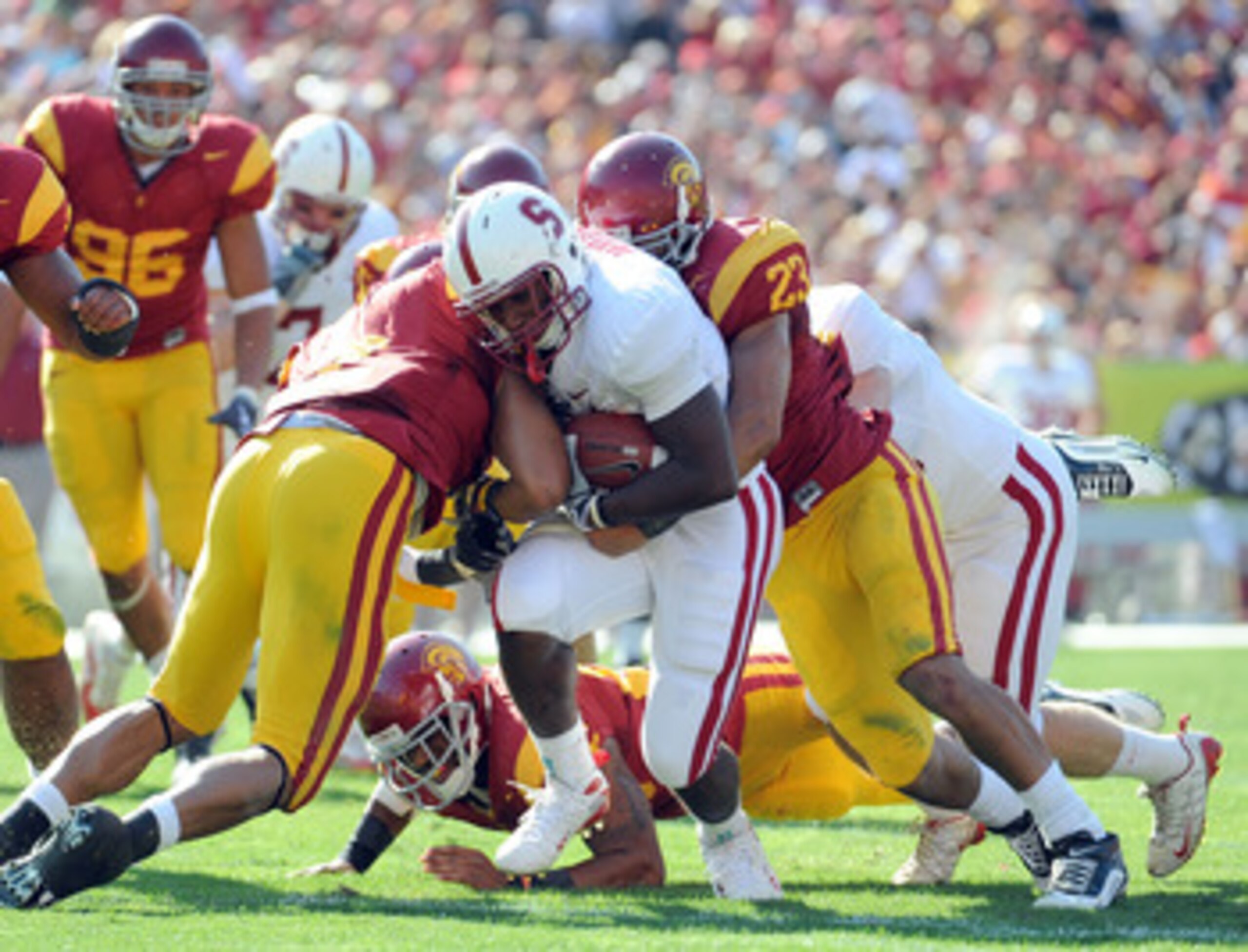 LOS ANGELES, CA - NOVEMBER 14:  Stepfan Taylor #31 of the Stanford Cardinal is tackled by Shane Horton #23 of the USC Trojans during the first half at the Los Angeles Memorial Coliseum on November 14, 2009 in Los Angeles, California.  (Photo by Harry How/