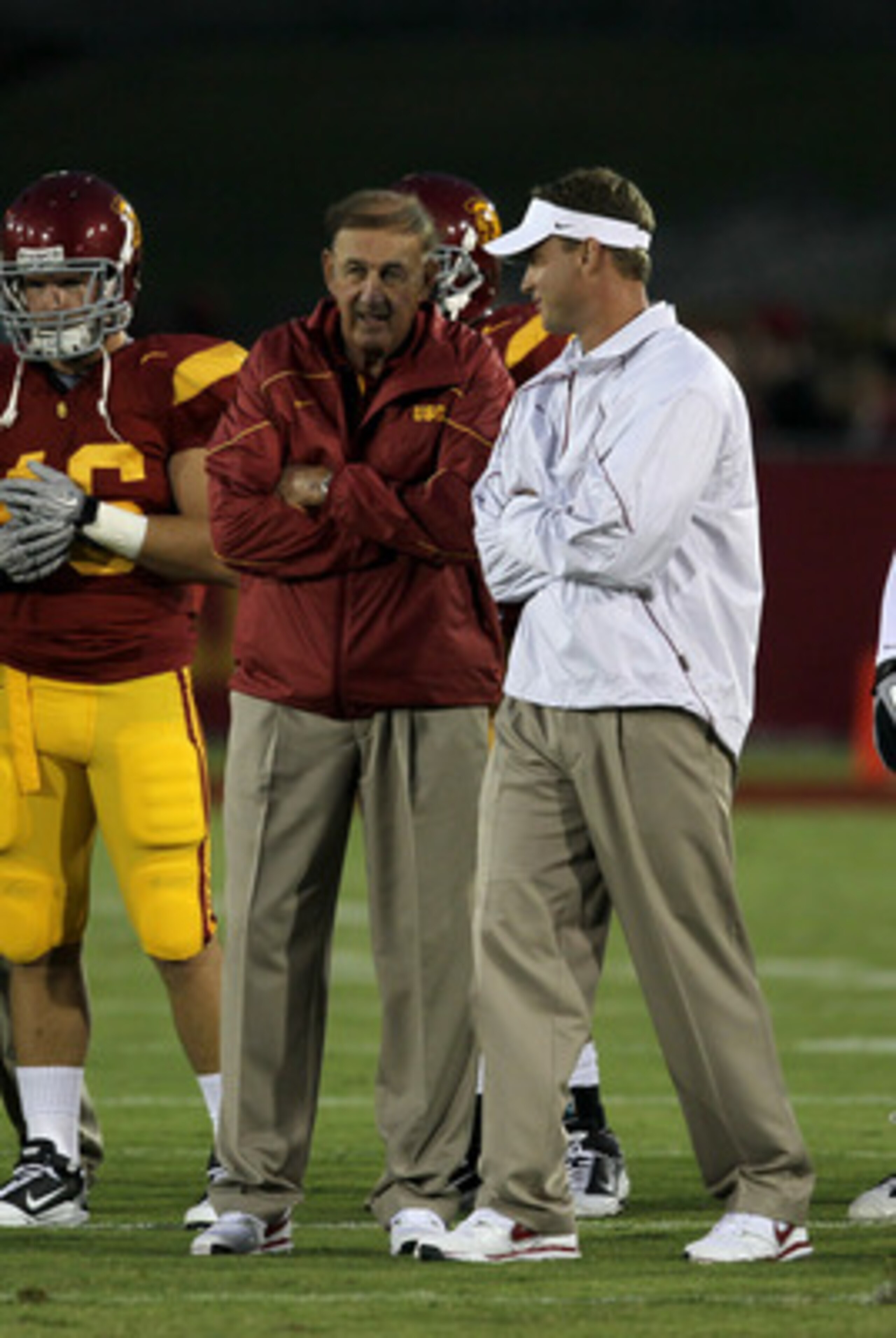 LOS ANGELES, CA - SEPTEMBER 11:  Head coach Lane Kiffin (R) and his father and defensive coordinator Monte Kiffin of the USC Trojans  talk during warmups for their game with the Virginia Cavaliers at Los Angeles Memorial Coliseum on September 11, 2010 in