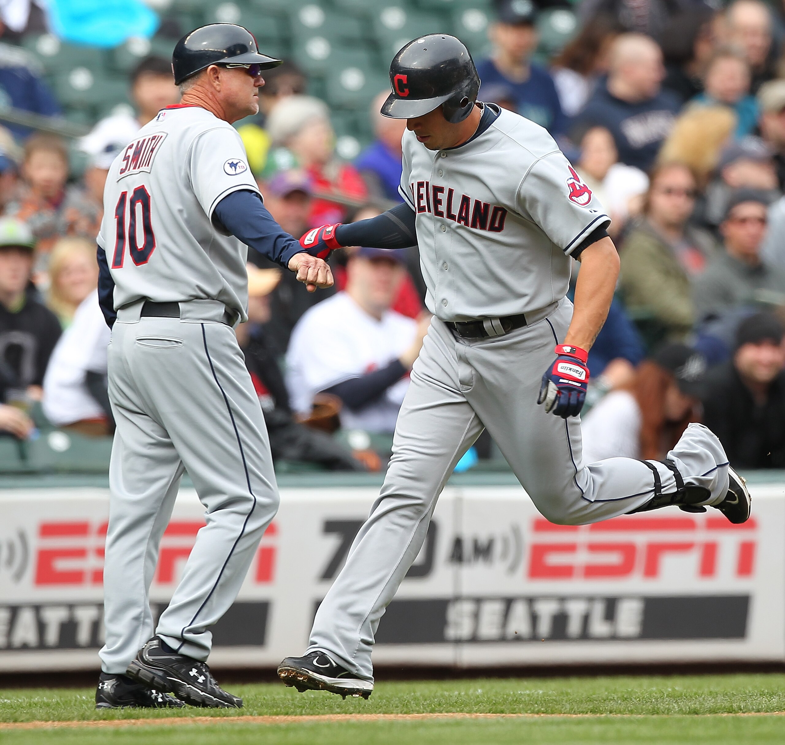 SEATTLE - APRIL 10:  Asdrubal Cabrera #13 of the Cleveland Indians is congratulated by third base coach Steve Smith #10 after hitting a solo home run in the first inning against the Seattle Mariners at Safeco Field on April 10, 2011 in Seattle, Washington