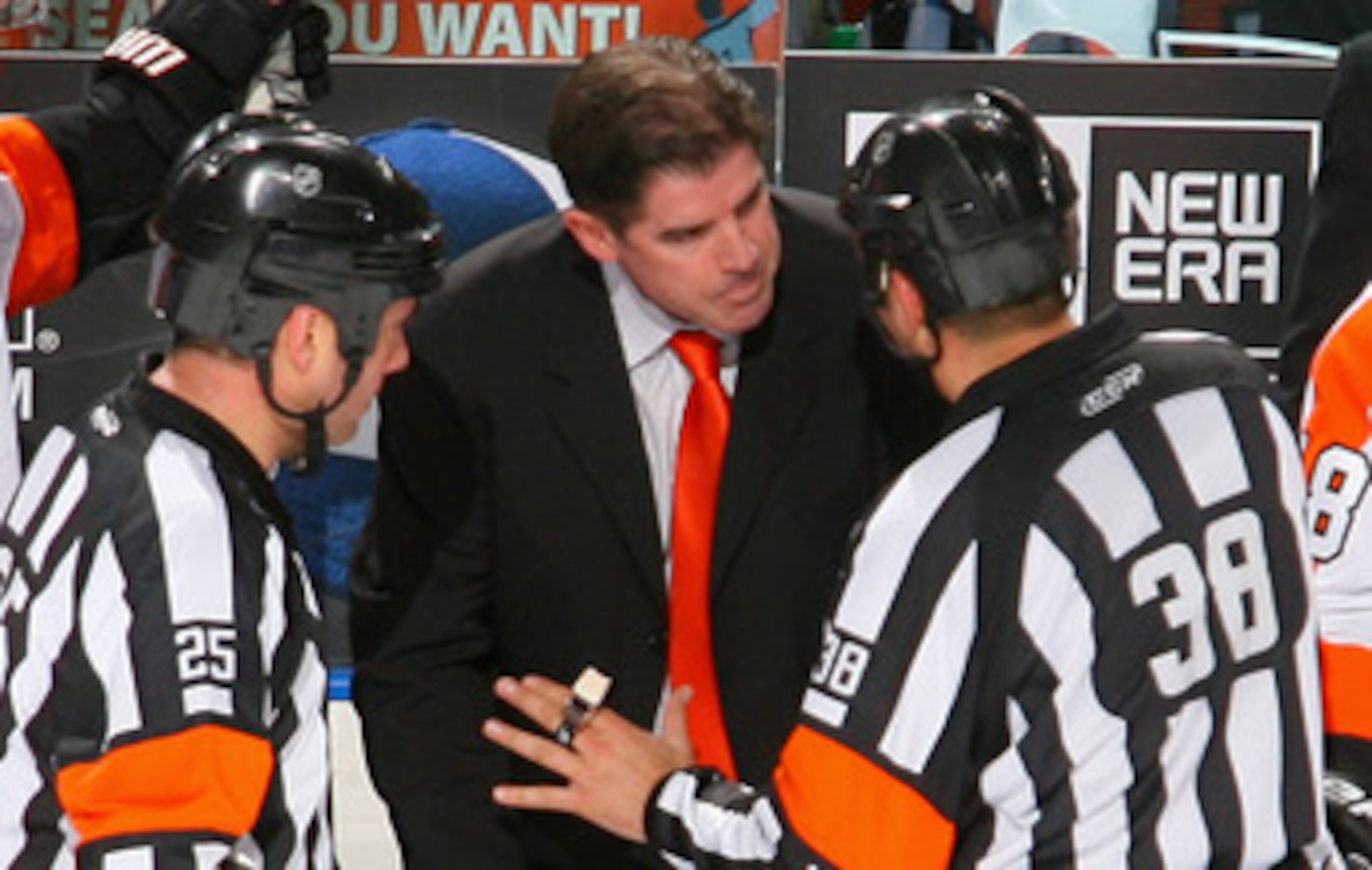 BUFFALO, NY - APRIL 20:  Head coach Peter Laviolette of the Philadelphia Flyers argues a penalty call with referee Francois St. Laurent #38 aginst the Buffalo Sabres  in Game Four of the Eastern Conference Quarterfinals during the 2011 NHL Stanley Cup Pla