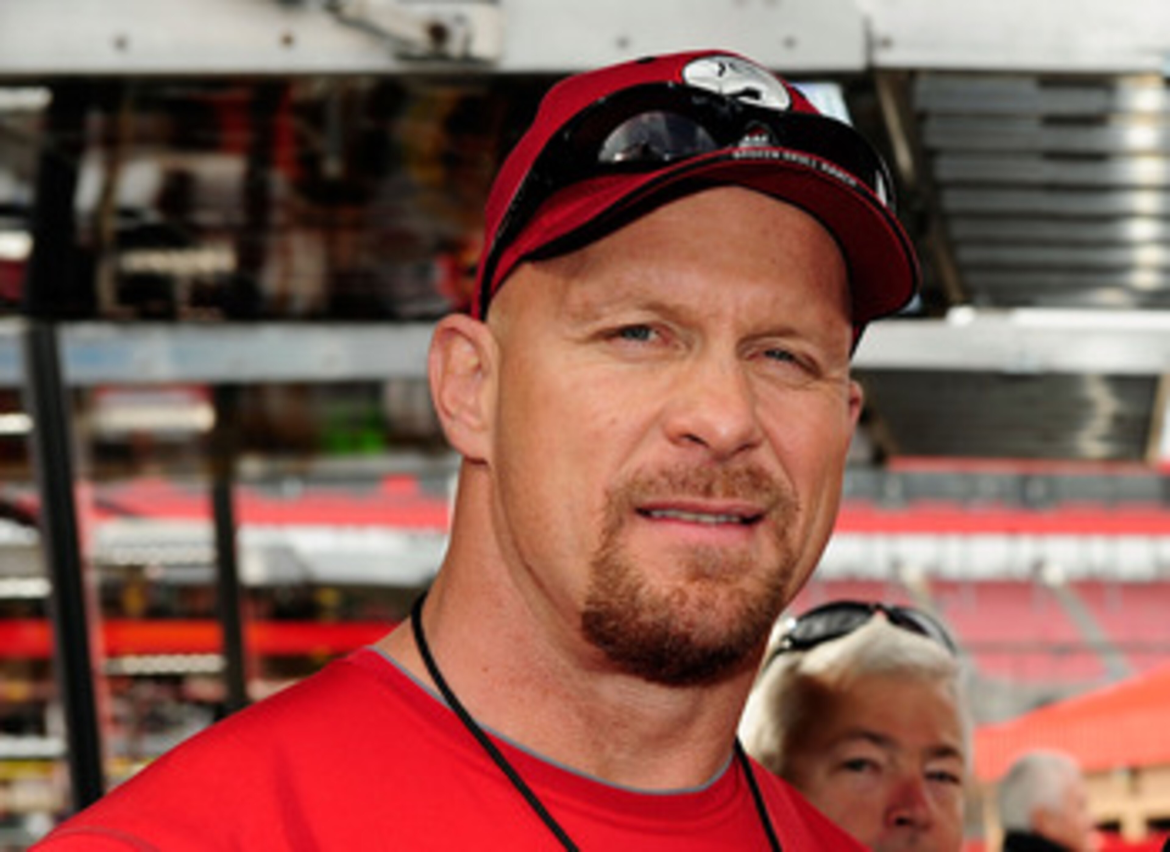 FONTANA, CA - FEBRUARY 21:  Actor Steve Austin and Carl Edwards, driver of the #99 Aflac Ford, pose for a photo in the garage area prior to the NASCAR Sprint Cup Series Auto Club 500 at Auto Club Speedway on February 21, 2010 in Fontana, California.  (Pho