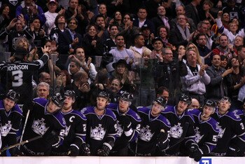 LOS ANGELES, CA - MARCH 21:  The Los Angeles Kings stand in the bench area after a goal by teammate Jarret Stoll #28 (not in photo) against the Calgary Flames in their NHL game at Staples Center on March 21, 2011 in Los Angeles, California. The Kings defe