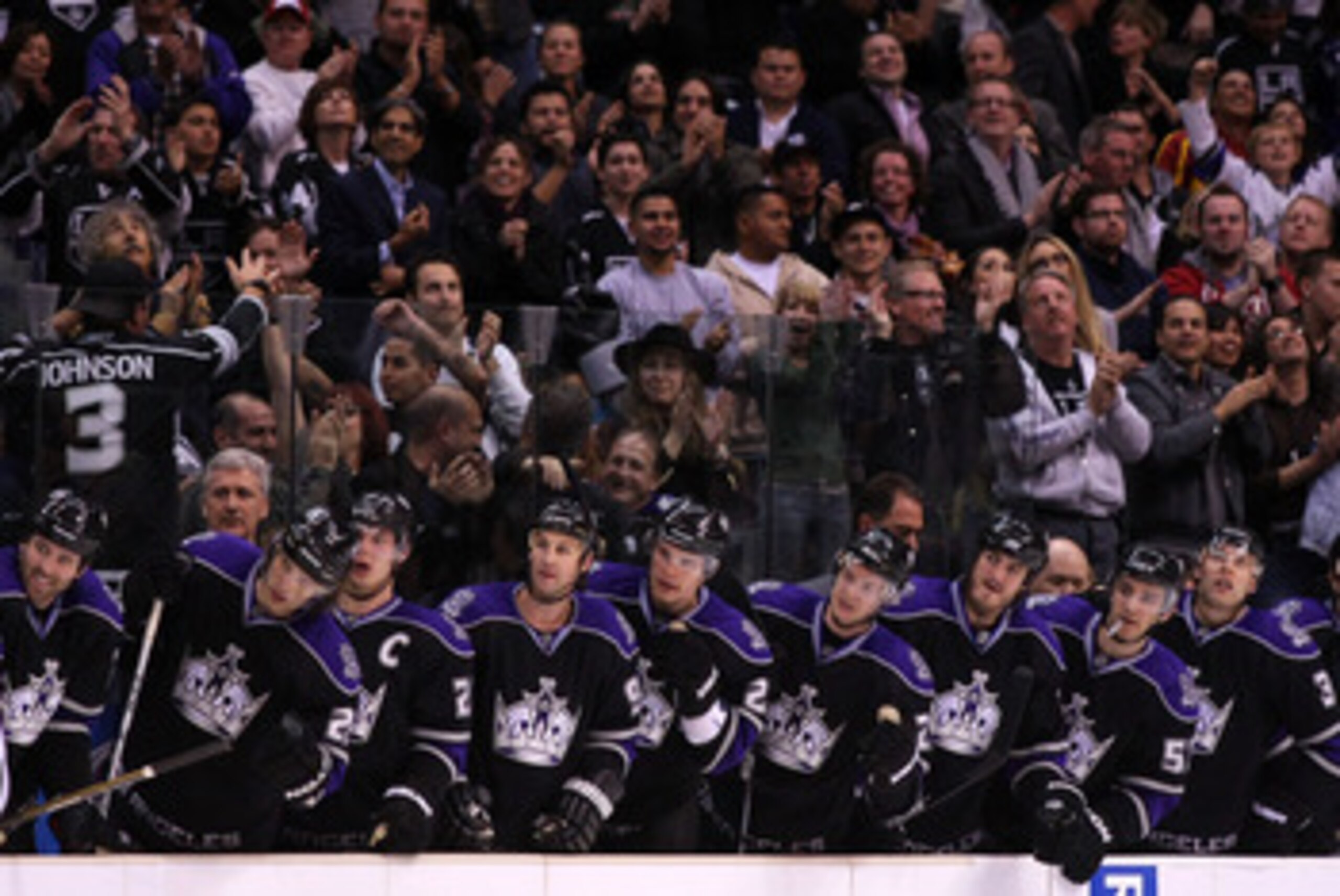 LOS ANGELES, CA - MARCH 21: The Los Angeles Kings stand in the bench area after a goal by teammate Jarret Stoll #28 (not in photo) against the Calgary Flames in their NHL game at Staples Center on March 21, 2011 in Los Angeles, California. The Kings defe LOS ANGELES, CA - MARCH 21: The Los Angeles Kings stand in the bench area after a goal by teammate Jarret Stoll #28 (not in photo) against the Calgary Flames in their NHL game at Staples Center on March 21, 2011 in Los Angeles, California. The Kings defe