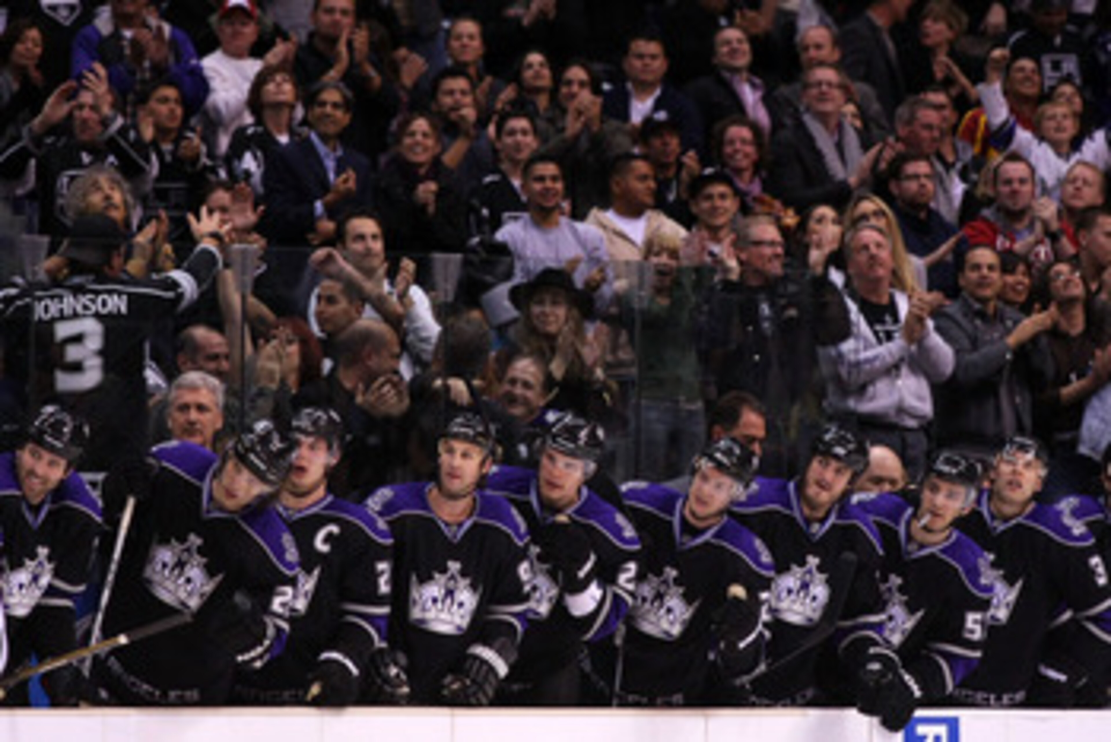 LOS ANGELES, CA - MARCH 21:  The Los Angeles Kings stand in the bench area after a goal by teammate Jarret Stoll #28 (not in photo) against the Calgary Flames in their NHL game at Staples Center on March 21, 2011 in Los Angeles, California. The Kings defe