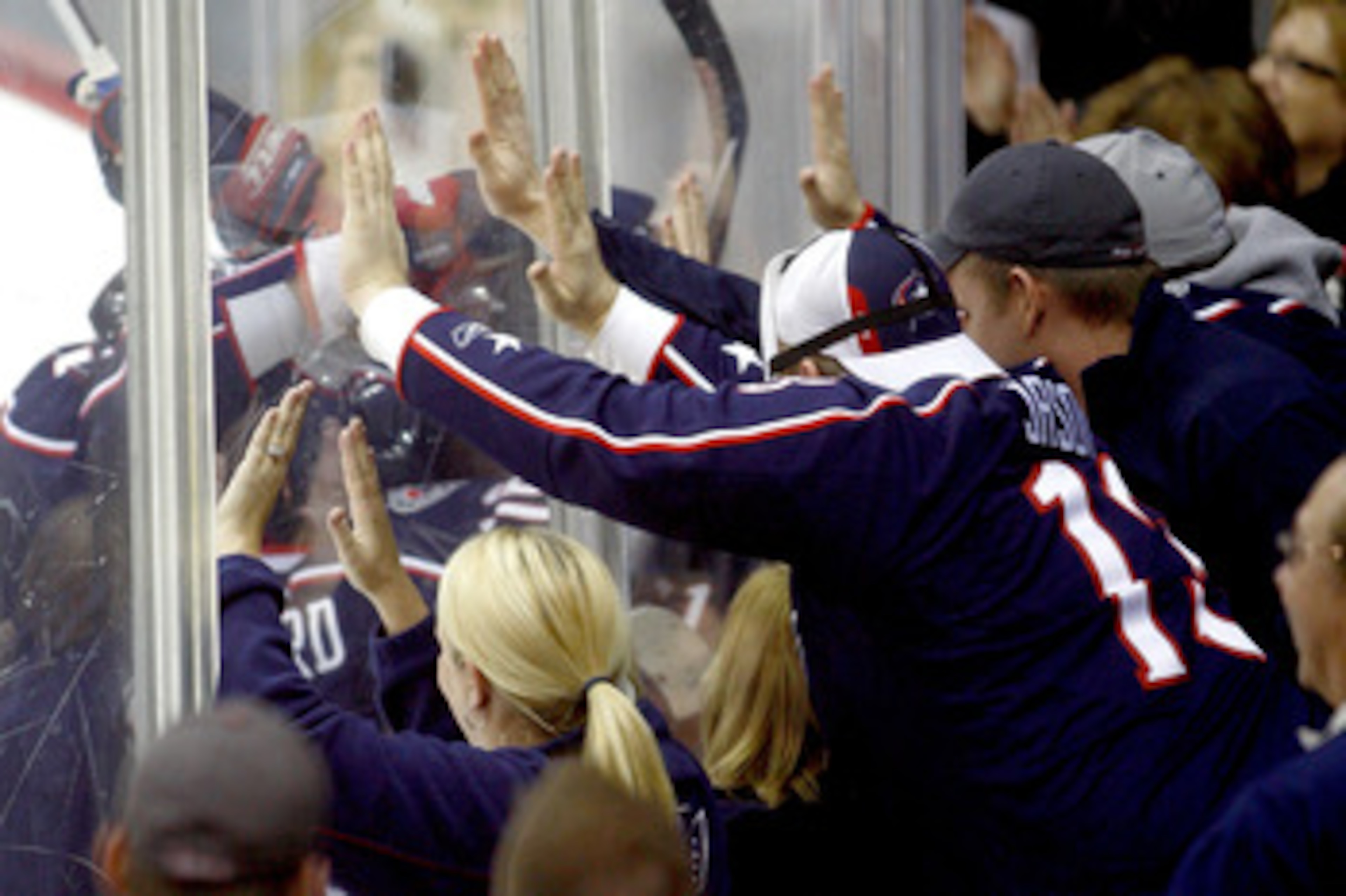 COLUMBUS,OH - DECEMBER 11:  Columbus Blue Jackets fans hit the glass while celebrating after Rick Nash #61 of the Columbus Blue Jackets scored the game winning goal against the New York Rangers during the third period on December 11, 2010 at Nationwide Ar
