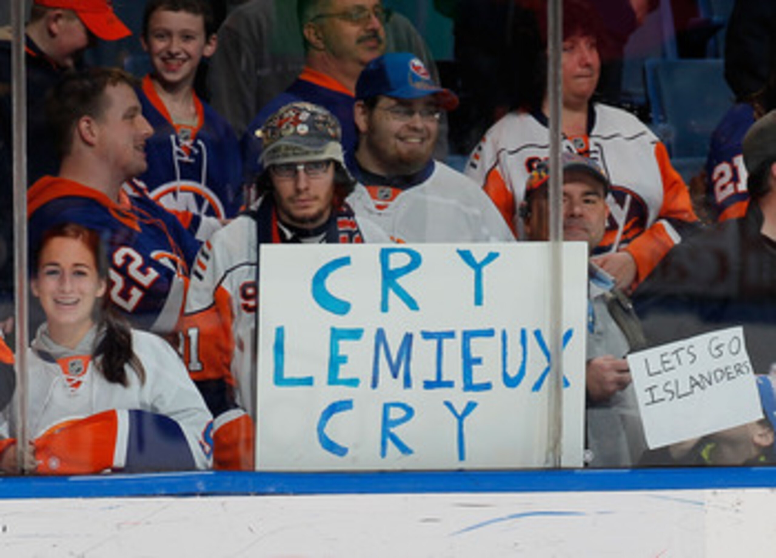UNIONDALE, NY - FEBRUARY 17: Fans hold a sign in reference to Mario Lemieux statements regarding a fight between the Islanders and Pittsburgh Penguins before an NHL hockey game between the New York Islanders and the Boston Bruins at the Nassau Coliseum o UNIONDALE, NY - FEBRUARY 17: Fans hold a sign in reference to Mario Lemieux statements regarding a fight between the Islanders and Pittsburgh Penguins before an NHL hockey game between the New York Islanders and the Boston Bruins at the Nassau Coliseum o