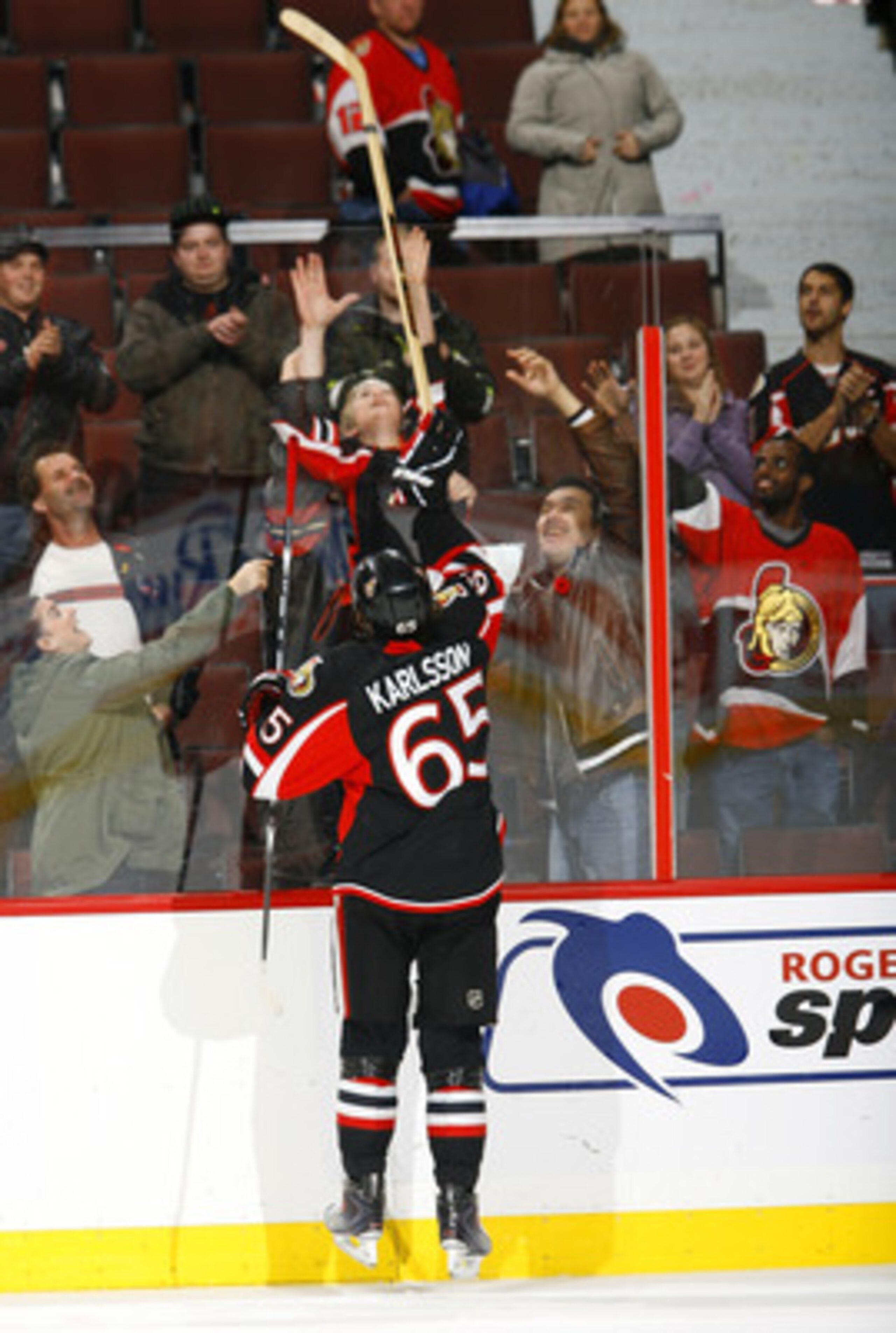 OTTAWA - NOVEMBER 09: Erik Karlsson #65 of the Ottawa Senators sends his 'Star of the Game' stick over the boards to a young fan at the end of a game against the Atlanta Thrashers at Scotiabank Place on November 9, 2010 in Ottawa, Ontario, Canada. The O OTTAWA - NOVEMBER 09: Erik Karlsson #65 of the Ottawa Senators sends his 'Star of the Game' stick over the boards to a young fan at the end of a game against the Atlanta Thrashers at Scotiabank Place on November 9, 2010 in Ottawa, Ontario, Canada. The O