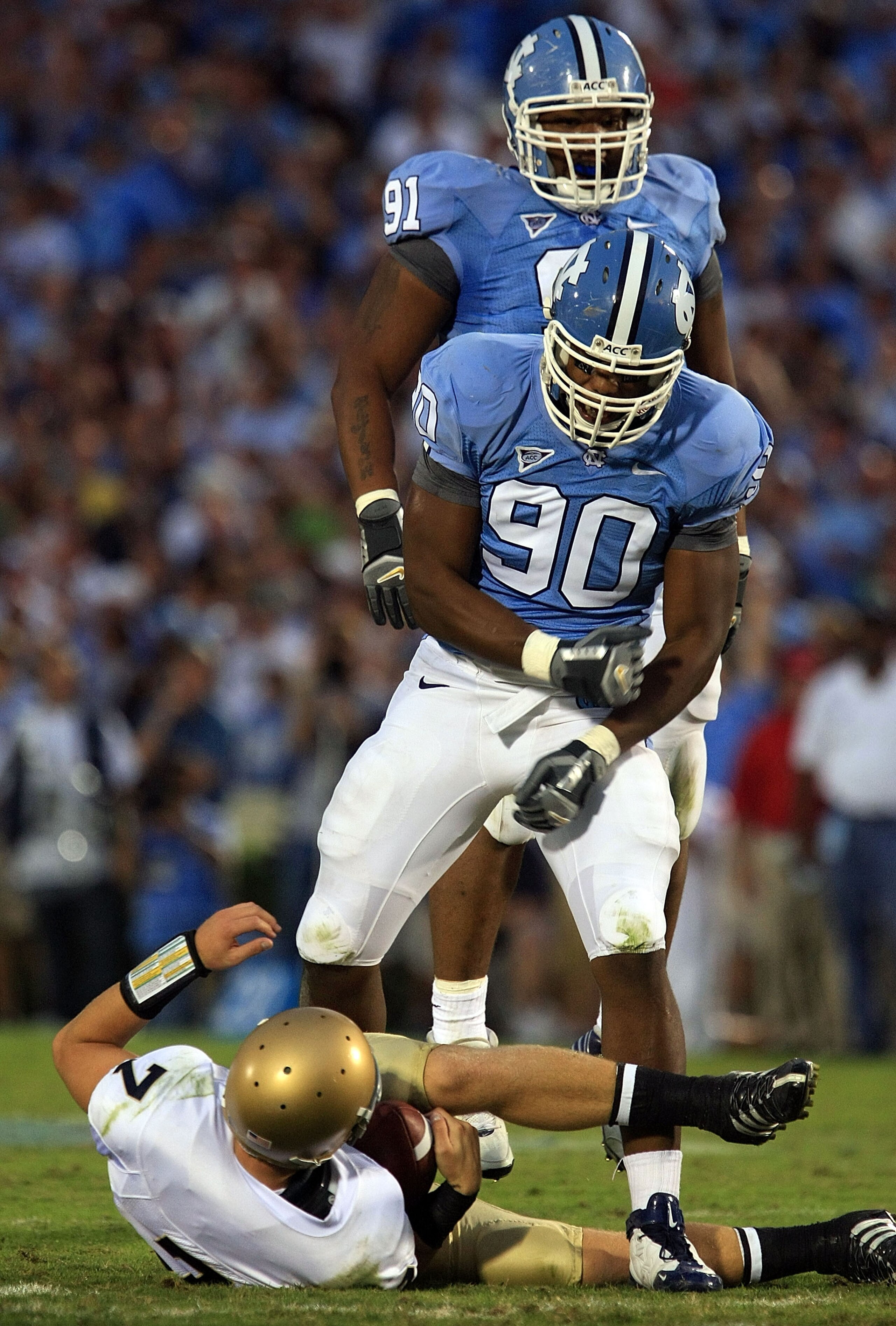 CHAPEL HILL, NC - OCTOBER 11: Quinton Coples #90 and Tydreke Powell #91 of the North Carolina Tar Heels celebrates after sacking Jimmy Clauson #7 of the Notre Dame Fighting Irish at Kenan Stadium October 11, 2008 in Chapel Hill, North Carolina. (Photo b CHAPEL HILL, NC - OCTOBER 11: Quinton Coples #90 and Tydreke Powell #91 of the North Carolina Tar Heels celebrates after sacking Jimmy Clauson #7 of the Notre Dame Fighting Irish at Kenan Stadium October 11, 2008 in Chapel Hill, North Carolina. (Photo b