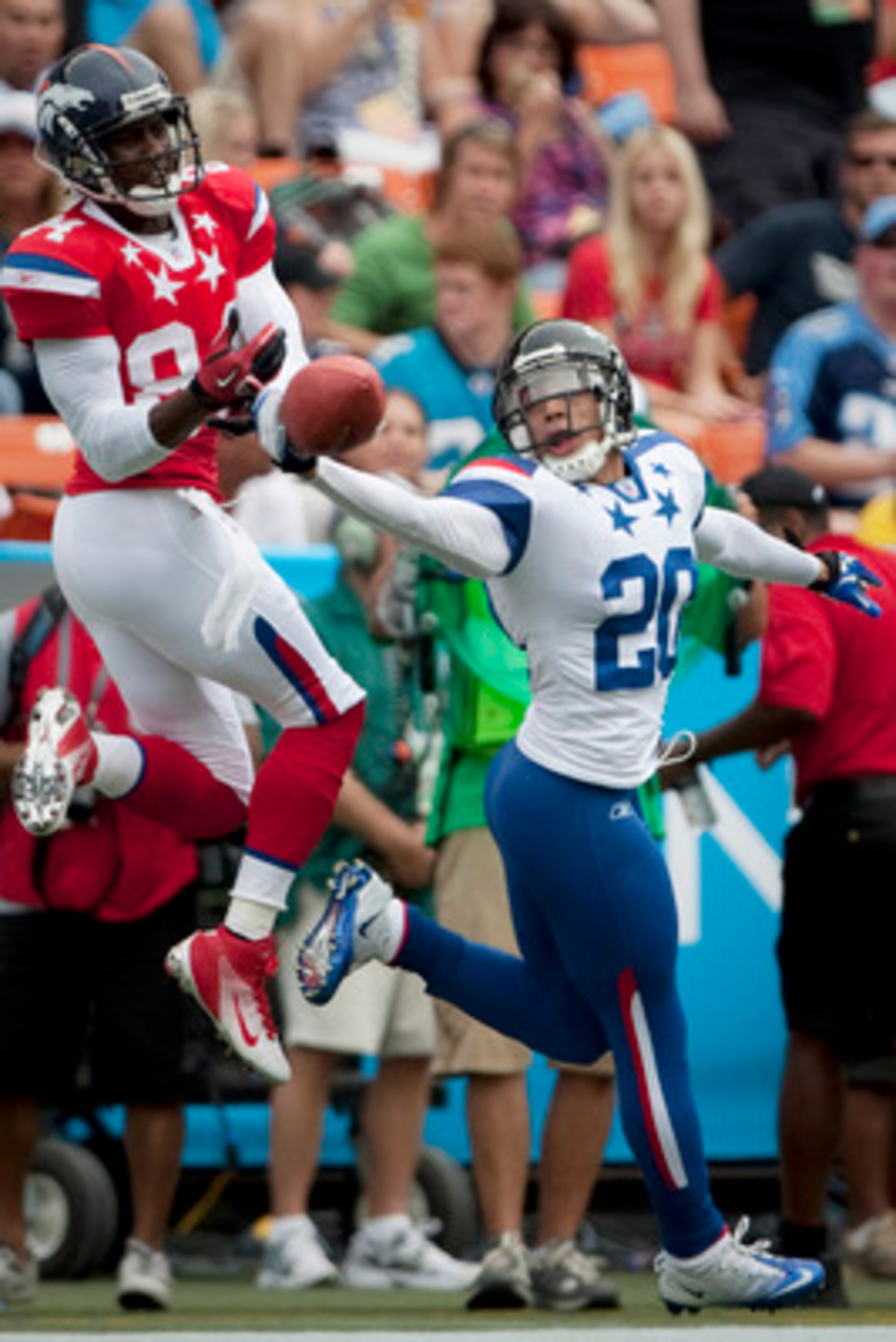 HONOLULU - JANUARY 30:  Brent Grimes, #20 of the Atlanta Falcons, tries to reel in a pass intended for Brandon Lloyd, #84 of the Denver Broncos, during the 2011 NFL Pro Bowl at Aloha Stadium on January 30, 2011 in Honolulu, Hawaii. NFC won 55-41 over the 