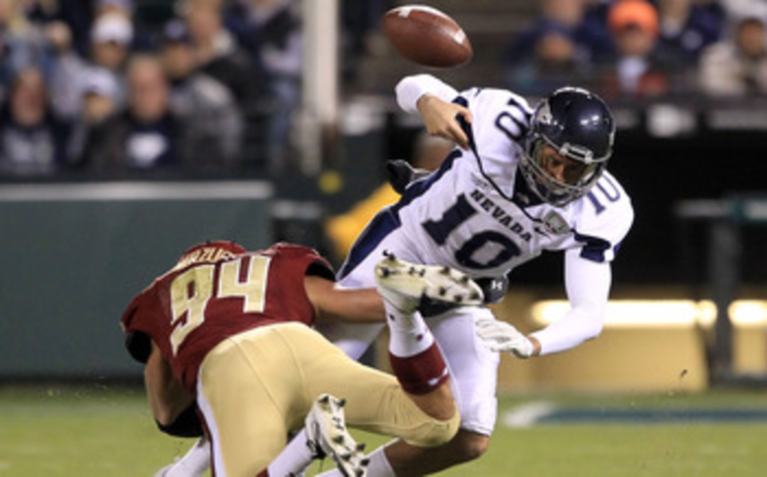 SAN FRANCISCO, CA - JANUARY 09:  Colin Kaepernick #10 of the Nevada Wolf Pack fumbles the ball after being hit by Mark Herzlich #94 of the Boston College during the Kraft Fight Hunger Bowl at AT&T Park on January 9, 2011 in San Francisco, California.  (Ph