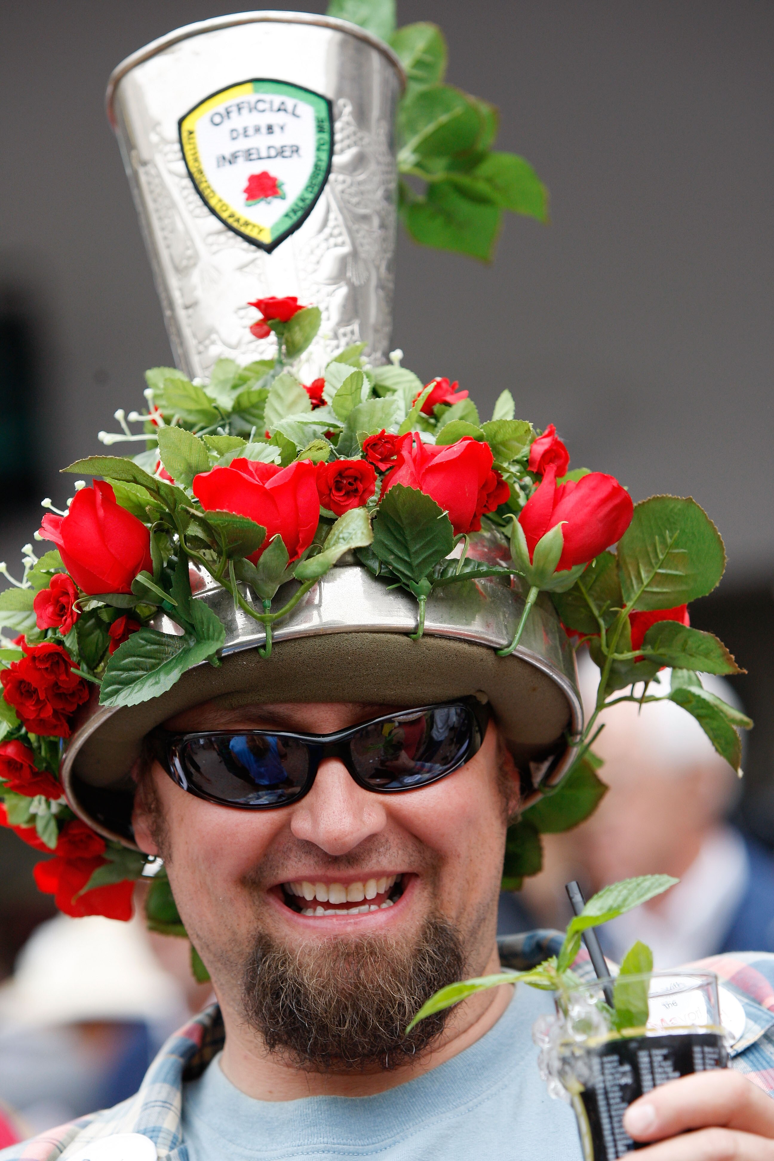 LOUISVILLE, KY - MAY 02:  A race fan with a mint julep in his hand and a hat shaped like one during the 135th running of the Kentucky Derby on May 2, 2009 at Churchill Downs in Louisville, Kentucky.  (Photo by Jamie Squire/Getty Images)