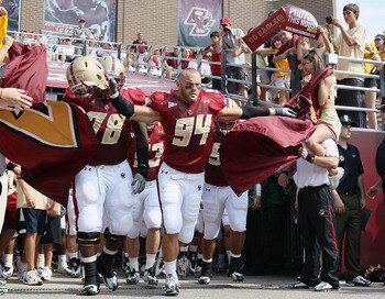 CHESTNUT HILL, MA - SEPTEMBER 25:  Mark Herzlich #94 and Thomas Claiborne #78 of the Boston College Eagles lead the team out on the field before the game against the Virginia Tech Hokies on September 25, 2010 at Alumni Stadium in Chestnut Hill, Massachuse