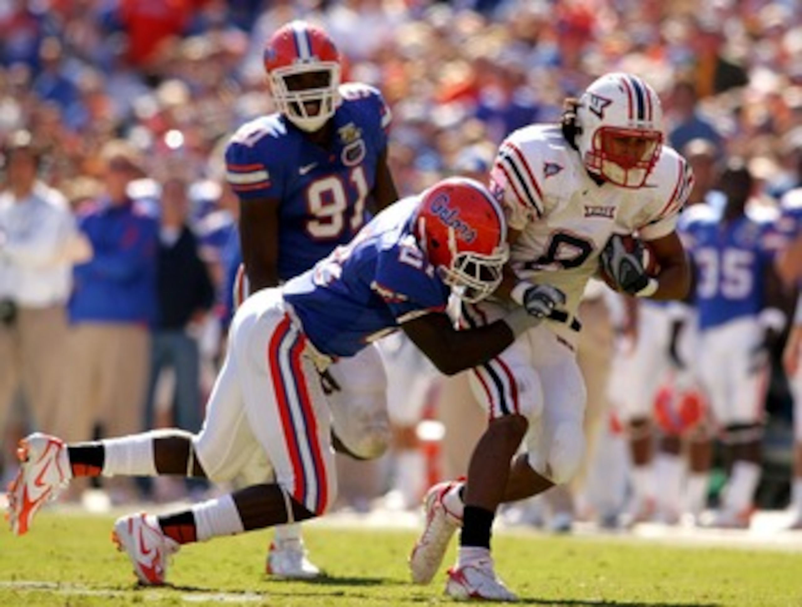 GAINESVILLE, FL - NOVEMBER 17:  Rob Housler #81 of the FAU Owls is tackled by Major Wright #21 of the Florida Gators during a game at Ben Hill Griffin Stadium on November 17, 2007 in Gainesville, Florida.  The Gators won the game 59-20.  (Photo by Sam Gre