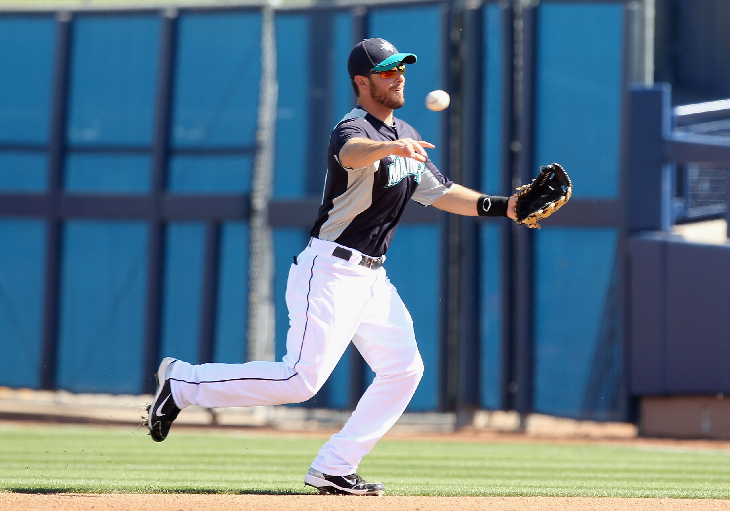 PEORIA, AZ - MARCH 04:  Infielder Dustin Ackley #13 of the Seattle Mariners fields a ground ball out against the Cincinnati Reds during the spring training game at Peoria Stadium on March 4, 2011 in Peoria, Arizona.  (Photo by Christian Petersen/Getty Ima