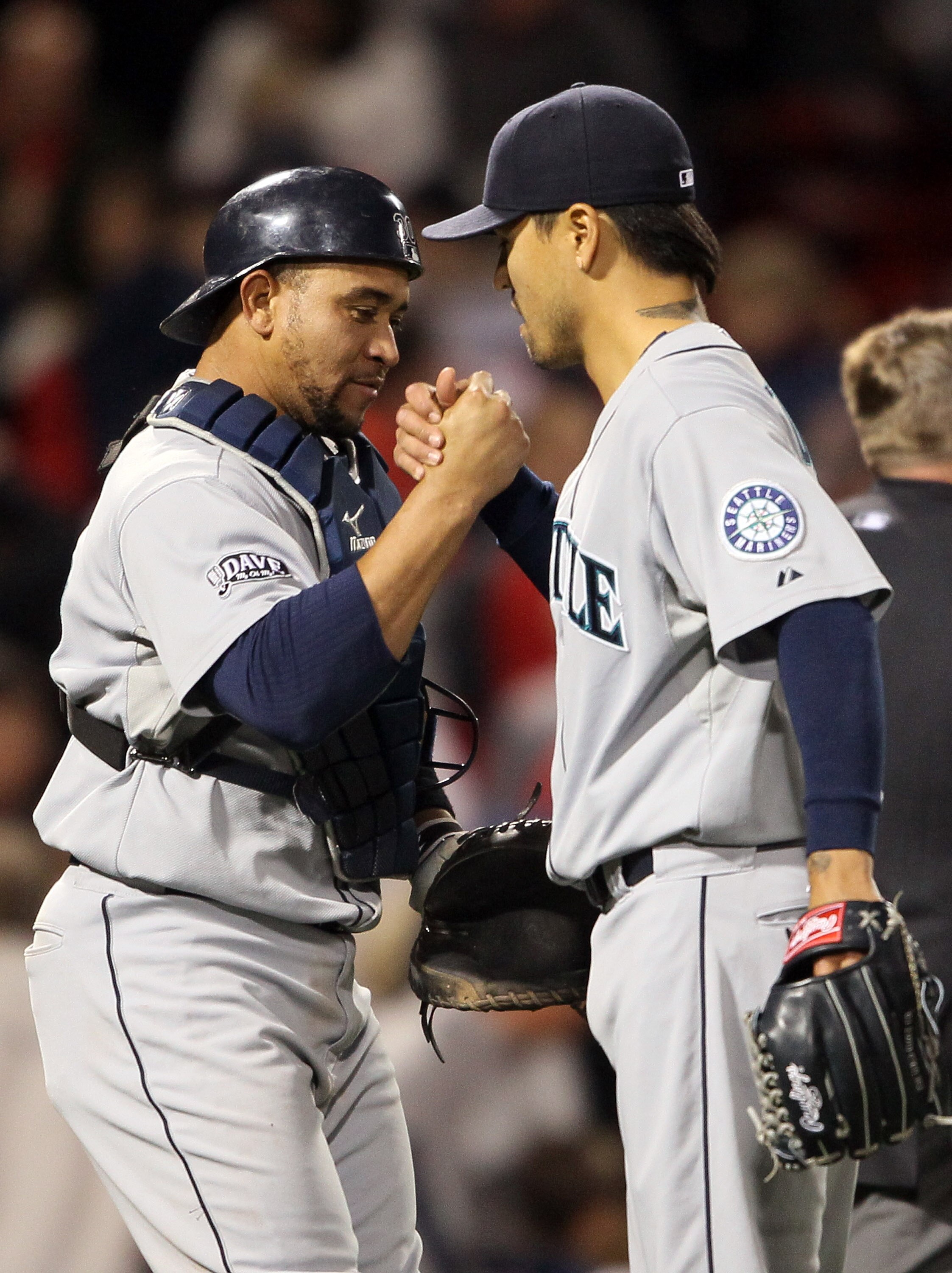 BOSTON, MA - APRIL 30:  Miguel Olivo #30 and Brandon League #43 of the Seattle Mariners celebrate he win over the Boston Red Sox on April 30, 2011 at Fenway Park in Boston, Massachusetts. The Seattle Mariners defeated the Boston Red Sox 2-0.  (Photo by El