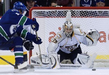 VANCOUVER, CANADA - APRIL 30: Henrik Sedin #33 of the Vancouver Canucks watches his puck slide wide past goalie Pekka Rinne #35 of the Nashville Predators during the first period in Game Two of the Western Conference Semifinals during the 2011 NHL Stanley