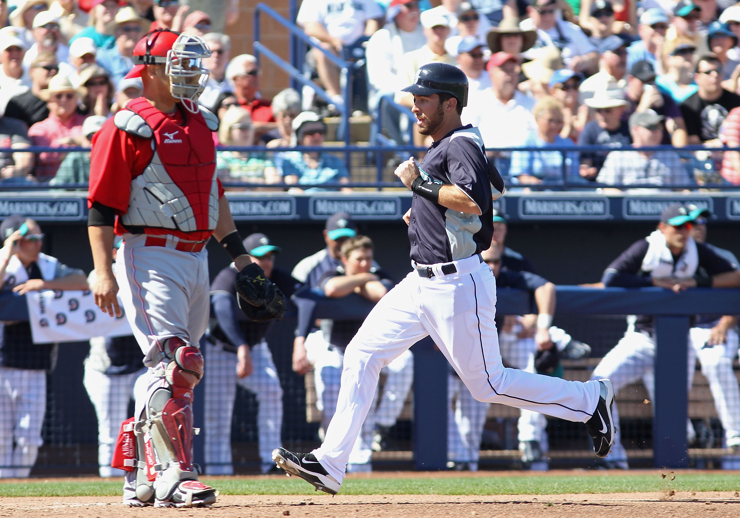 PEORIA, AZ - MARCH 04:  Dustin Ackley #13 of the Seattle Mariners scores a run on a sacrifice fly hit by Ichiro Suzuki (not pictured) during the third inning of the spring training game against the Cincinnati Reds at Peoria Stadium on March 4, 2011 in Peo