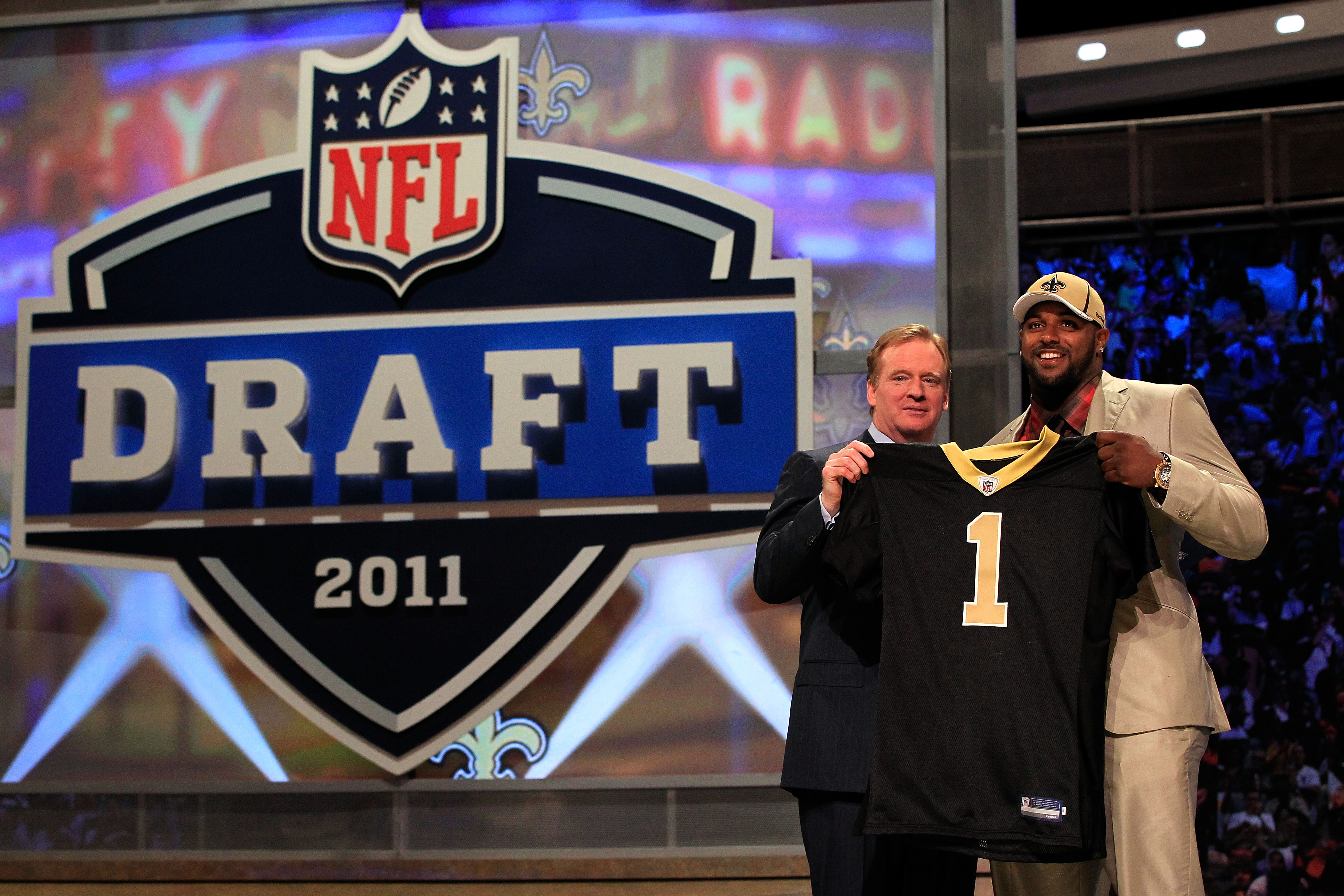 NEW YORK, NY - APRIL 28:  NFL Commissioner Roger Goodell (L) poses for a photo with Cameron Jordan, #24 overall pick by the New Orleans Saints, holds up a jersey on stage during the 2011 NFL Draft at Radio City Music Hall on April 28, 2011 in New York Cit