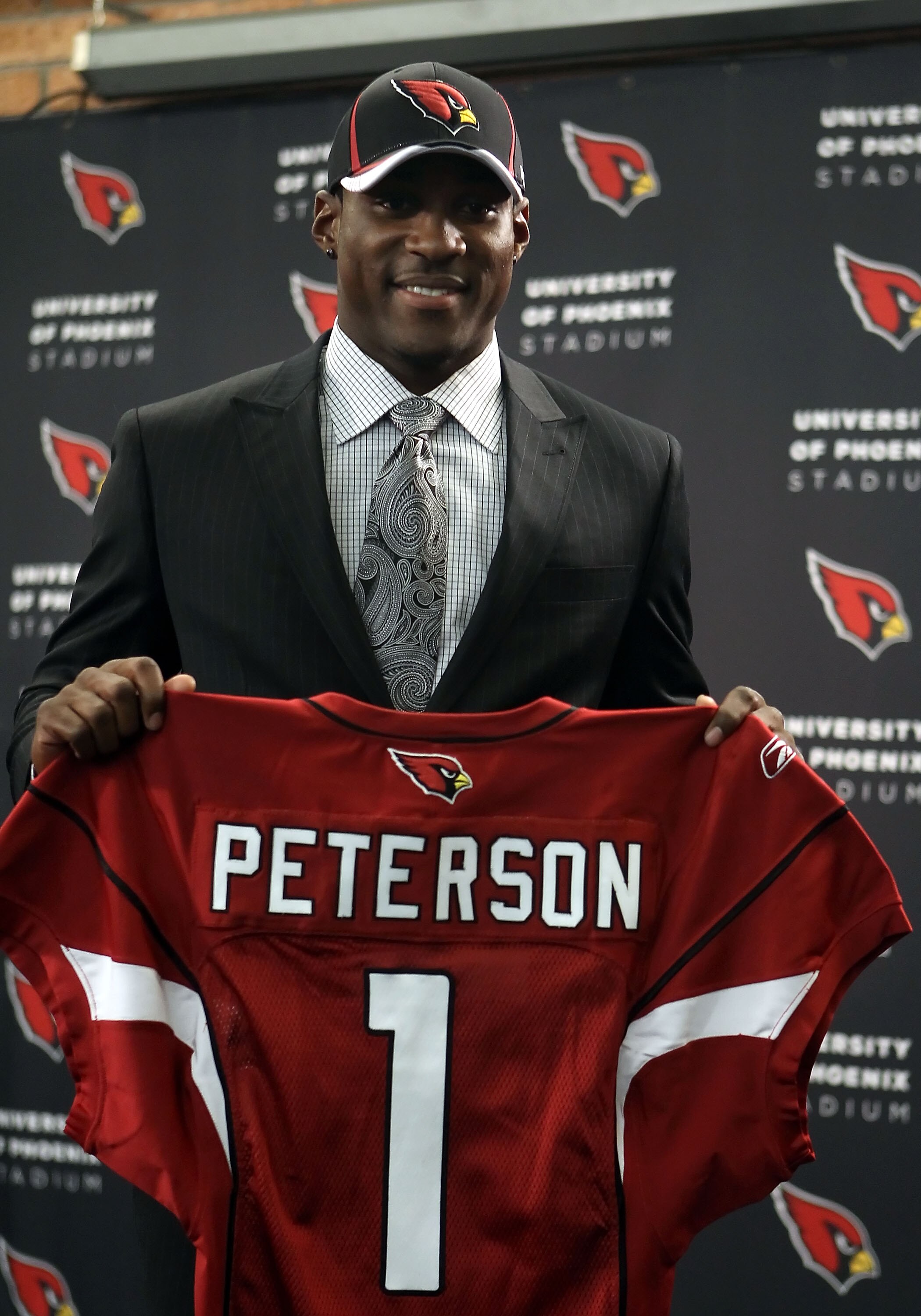 TEMPE, AZ - APRIL 29:  First round draft pick Patrick Peterson of the Arizona Cardinals poses with a team jersey during a press conference to introduce him at the team's training center auditorium on April 29, 2011 in Tempe, Arizona.  (Photo by Christian