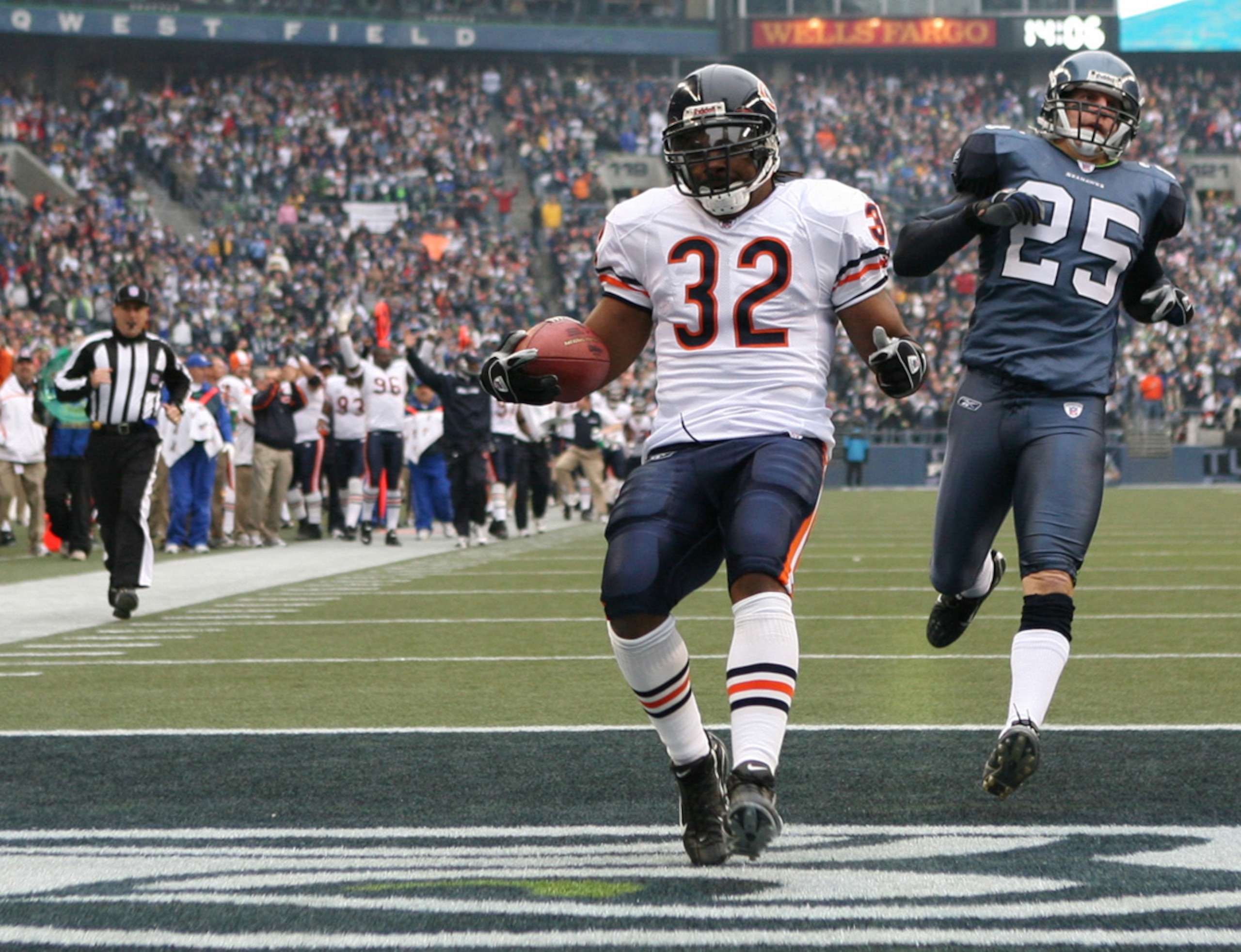 SEATTLE - NOVEMBER 18:  Running back Cedric Benson #32 of the Chicago Bears scores a touchdown in the first quarter against Brian Russell #25 of the Seattle Seahawks at Qwest Field on November 18, 2007 in Seattle, Washington. The Seahawks defeated the Bea
