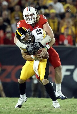 TUCSON, AZ - SEPTEMBER 18: Quarterback Ricky Stanzi #12 of the Iowa Hawkeyes is sacked by Brooks Reed #42 of the Arizona Wildcats during the third quarter of the college football game at Arizona Stadium on September 18, 2010 in Tucson, Arizona. The Wild TUCSON, AZ - SEPTEMBER 18: Quarterback Ricky Stanzi #12 of the Iowa Hawkeyes is sacked by Brooks Reed #42 of the Arizona Wildcats during the third quarter of the college football game at Arizona Stadium on September 18, 2010 in Tucson, Arizona. The Wild