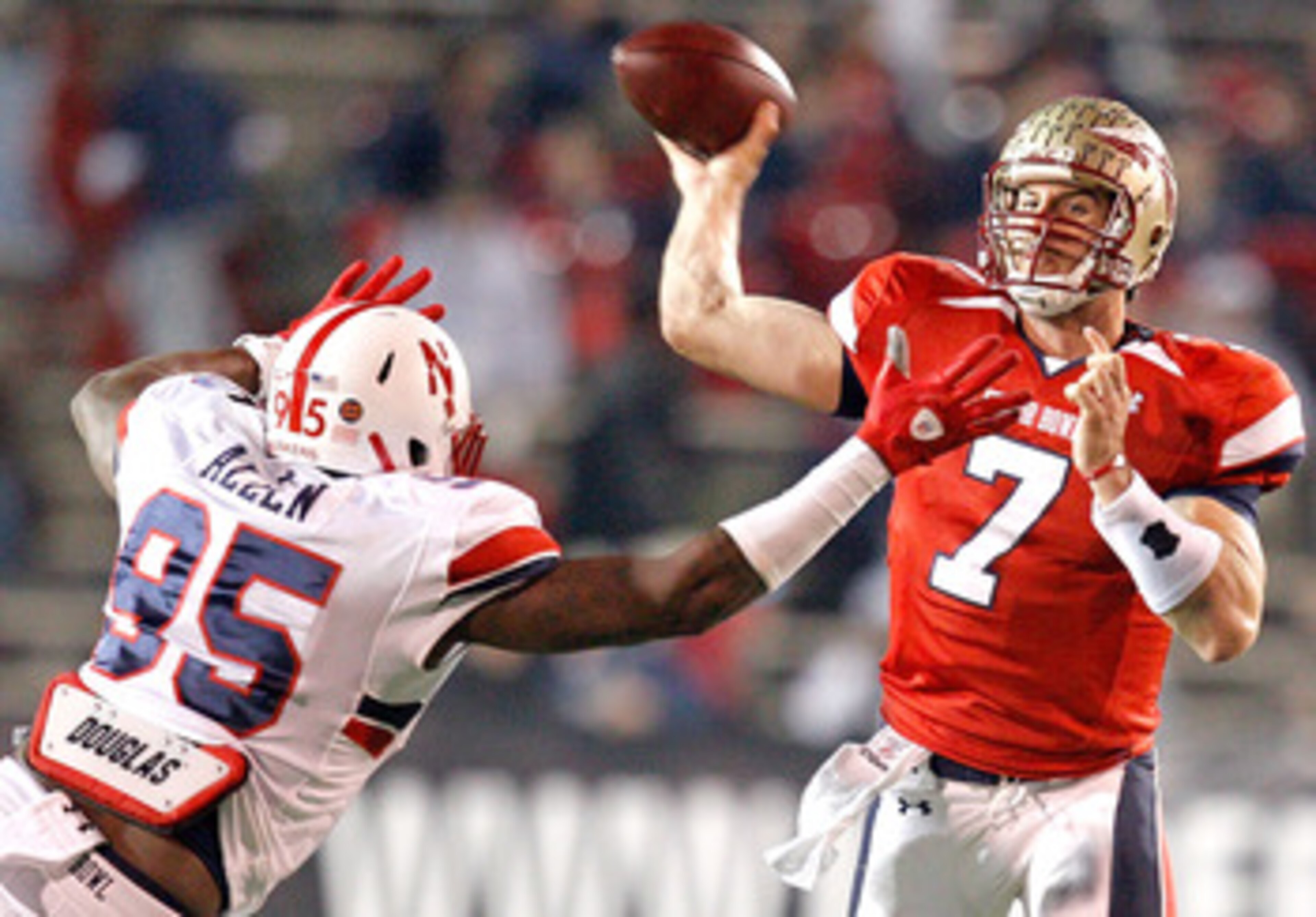 MOBILE, AL - JANUARY 29: Quarterback  Christian Ponder #7 of the South Team passes over defensive lineman Pierre Allen #95 North Team during the fourth quarter of the Under Armour Senior Bowl on January 29, 2011 at Ladd-Pebbles Stadium in Mobile, Alabama.