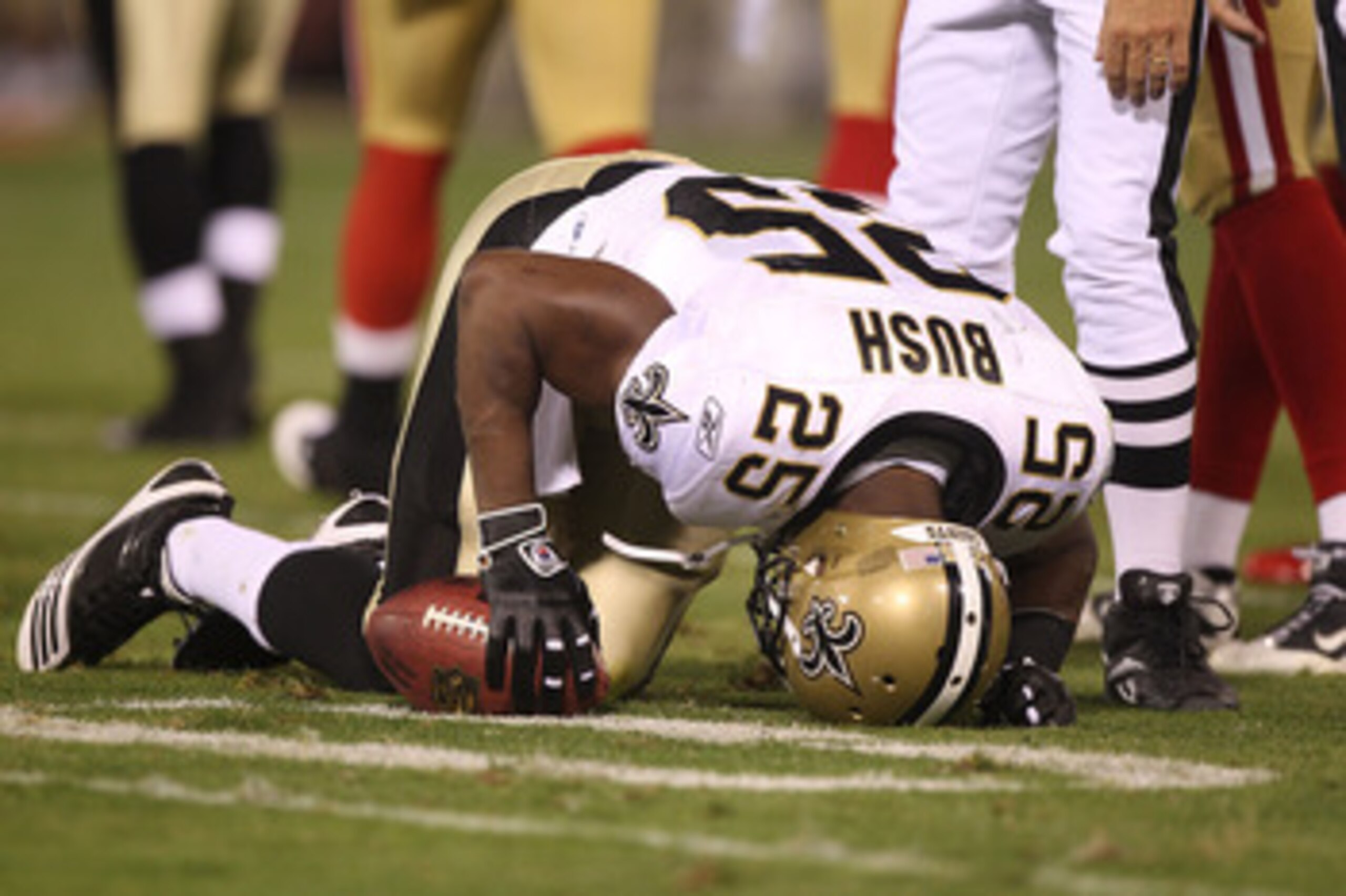 SAN FRANCISCO - SEPTEMBER 20:  Reggie Bush #25 of the New Orleans Saints lies on the ground injured against the San Francisco 49ers during an NFL game at Candlestick Park on September 20, 2010 in San Francisco, California.  (Photo by Jed Jacobsohn/Getty I