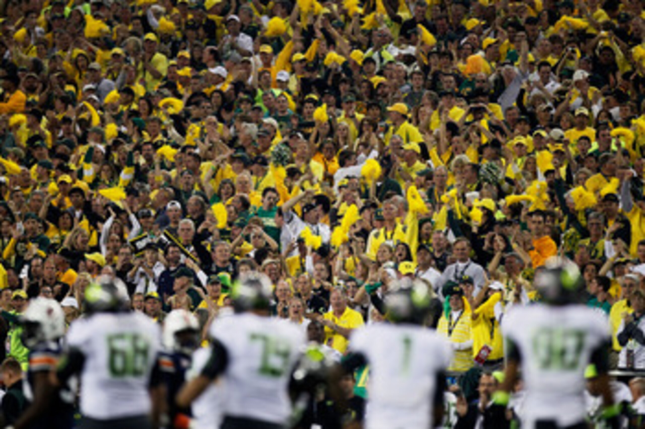 GLENDALE, AZ - JANUARY 10:  The Oregon Ducks fans cheer as the Ducks offense is on the field against the Auburn Tigers defense during the Tostitos BCS National Championship Game at University of Phoenix Stadium on January 10, 2011 in Glendale, Arizona.  (