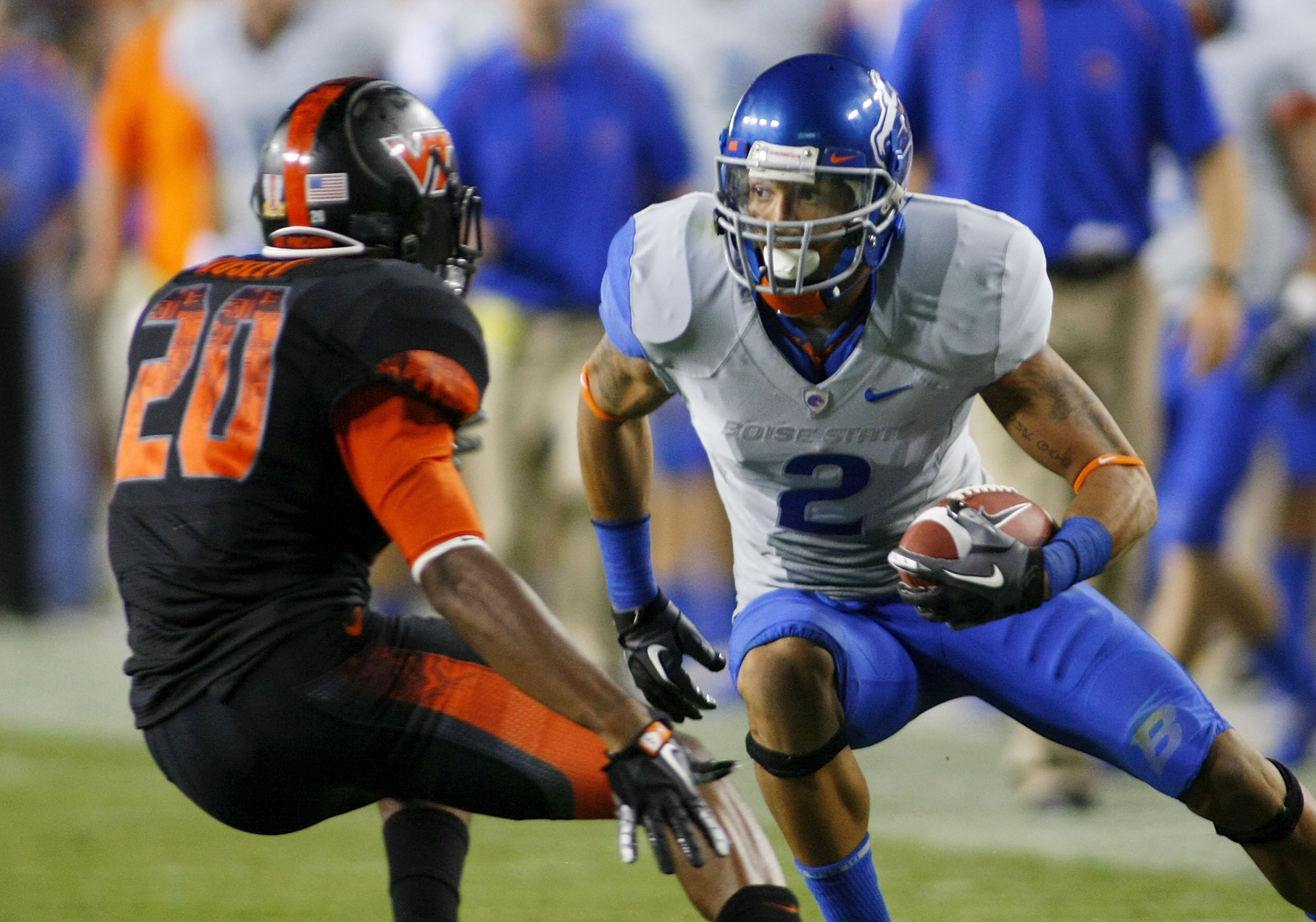 LANDOVER, MD - SEPTEMBER 06:  Wide receiver #2 Austin Pettis of the Boise State Broncos tries to avoid cornerback #21 Rashad Carmichael of the Virginia Tech Hokies at FedExField on September 6, 2010 in Landover, Maryland.  (Photo by Geoff Burke/Getty Imag