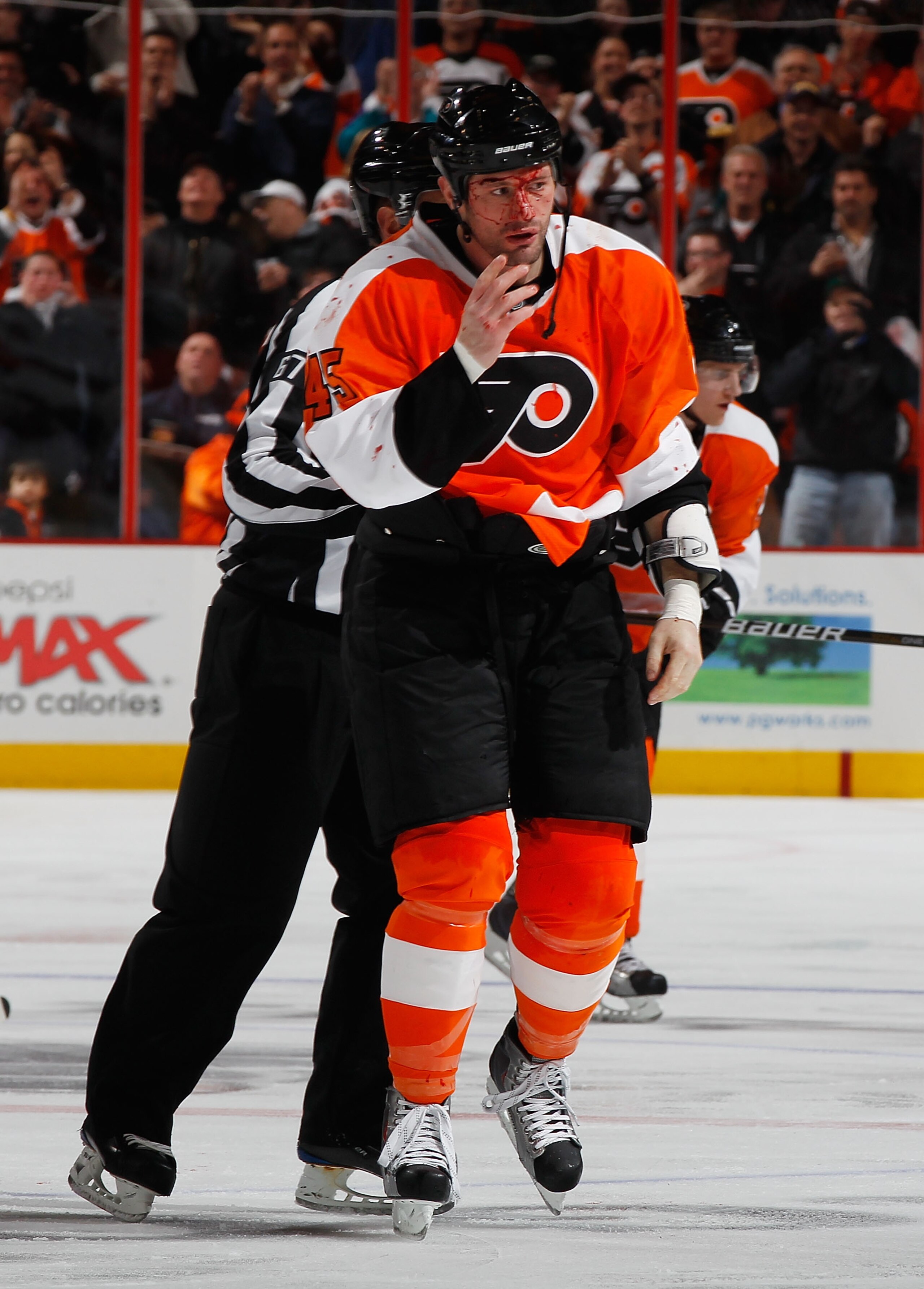 PHILADELPHIA - FEBRUARY 22:  Jody Shelley #45 of the Philadelphia Flyers is escorted off the ice after fighting Nolan Yonkman (not pictured) of the Phoenix Coyotes during the second period on February 22, 2011 at the Wells Fargo Center in Philadelphia, Pe