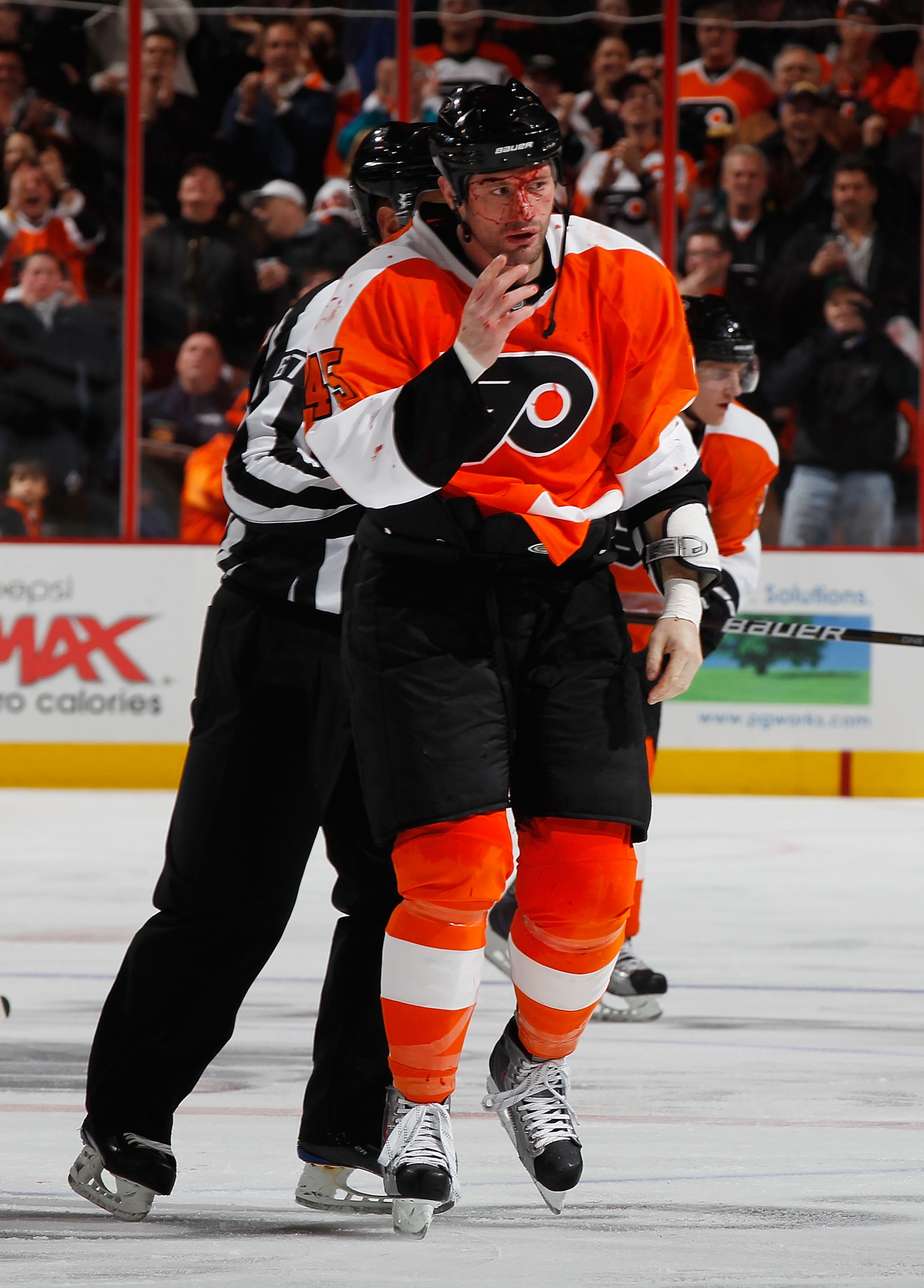 PHILADELPHIA - FEBRUARY 22:  Jody Shelley #45 of the Philadelphia Flyers is escorted off the ice after fighting Nolan Yonkman (not pictured) of the Phoenix Coyotes during the second period on February 22, 2011 at the Wells Fargo Center in Philadelphia, Pe