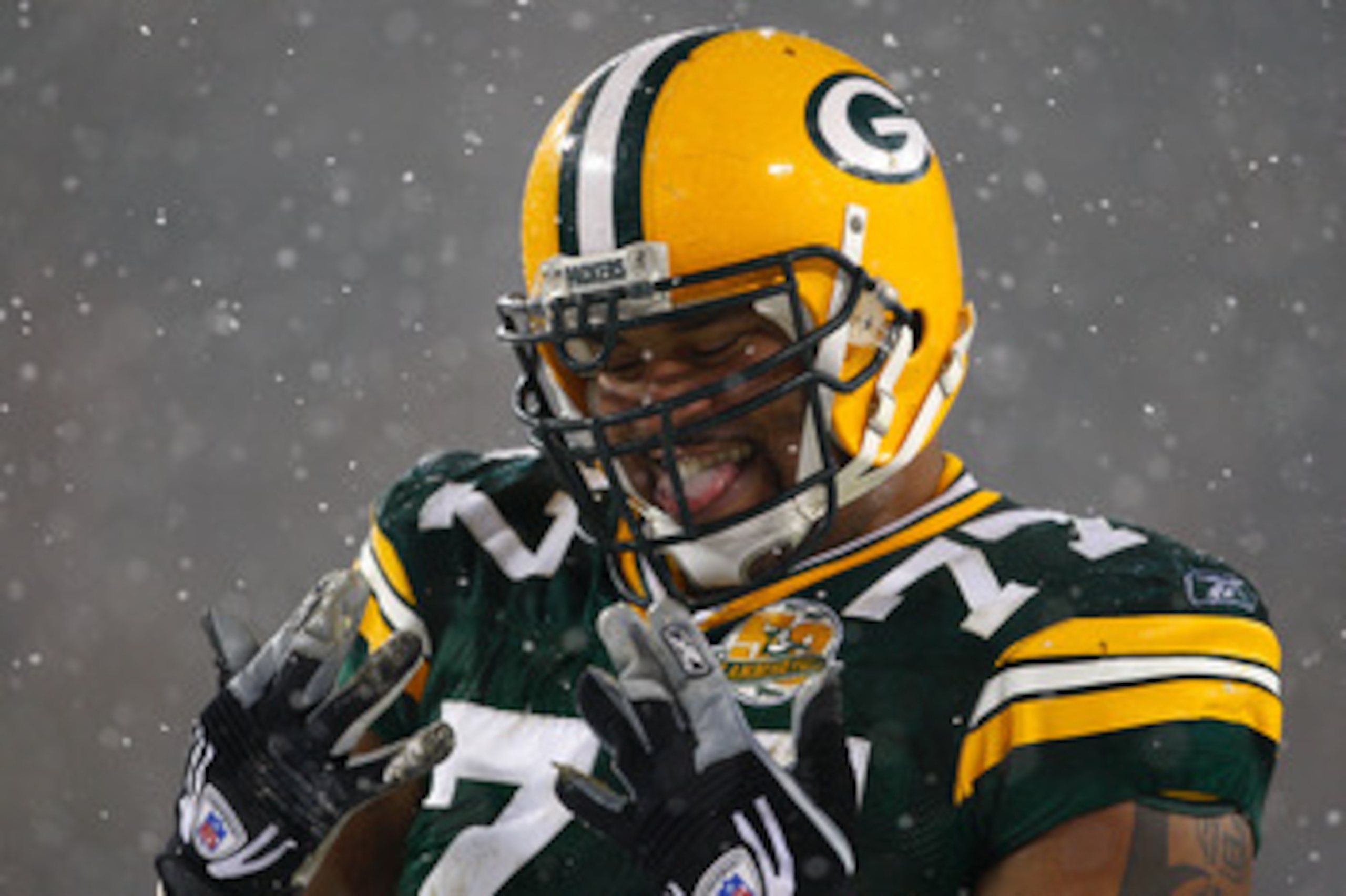 GREEN BAY, WI - JANUARY 12:  Defensive end Cullen Jenkins #77 of the Green Bay Packers smiles in the fourth quarter against the Seattle Seahawks during the NFC divisional playoff game on January 12, 2008 at Lambeau Field in Green Bay, Wisconsin.  (Photo b