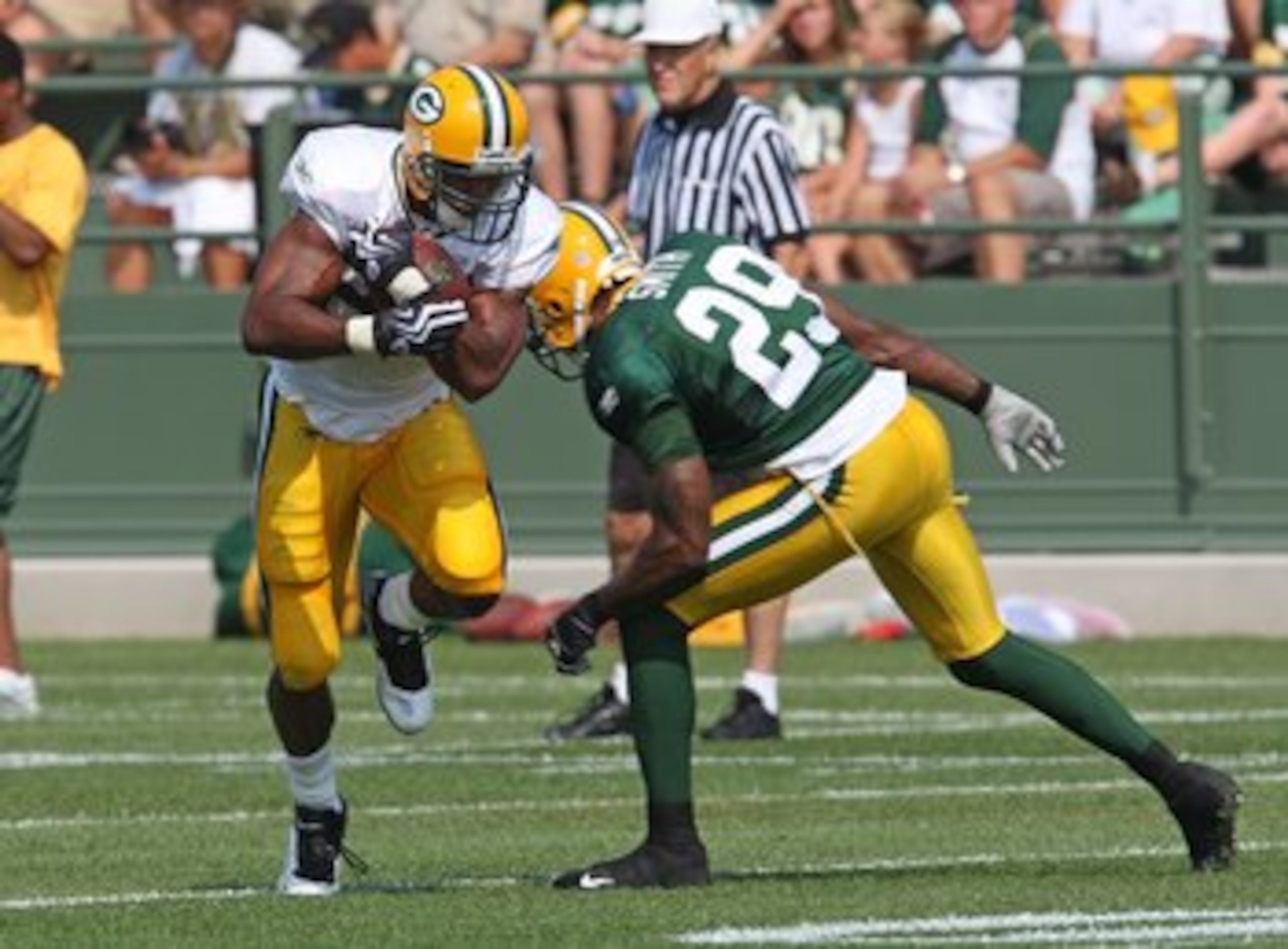 GREEN BAY, WI - AUGUST 03: Ryan Grant #25 of the Green Bay Packers runs past Anthony Smith #29 during practice at summer training camp on August 3, 2009 at the Ray Nitschke Field in Green Bay, Wisconsin. (Photo by Jonathan Daniel/Getty Images)