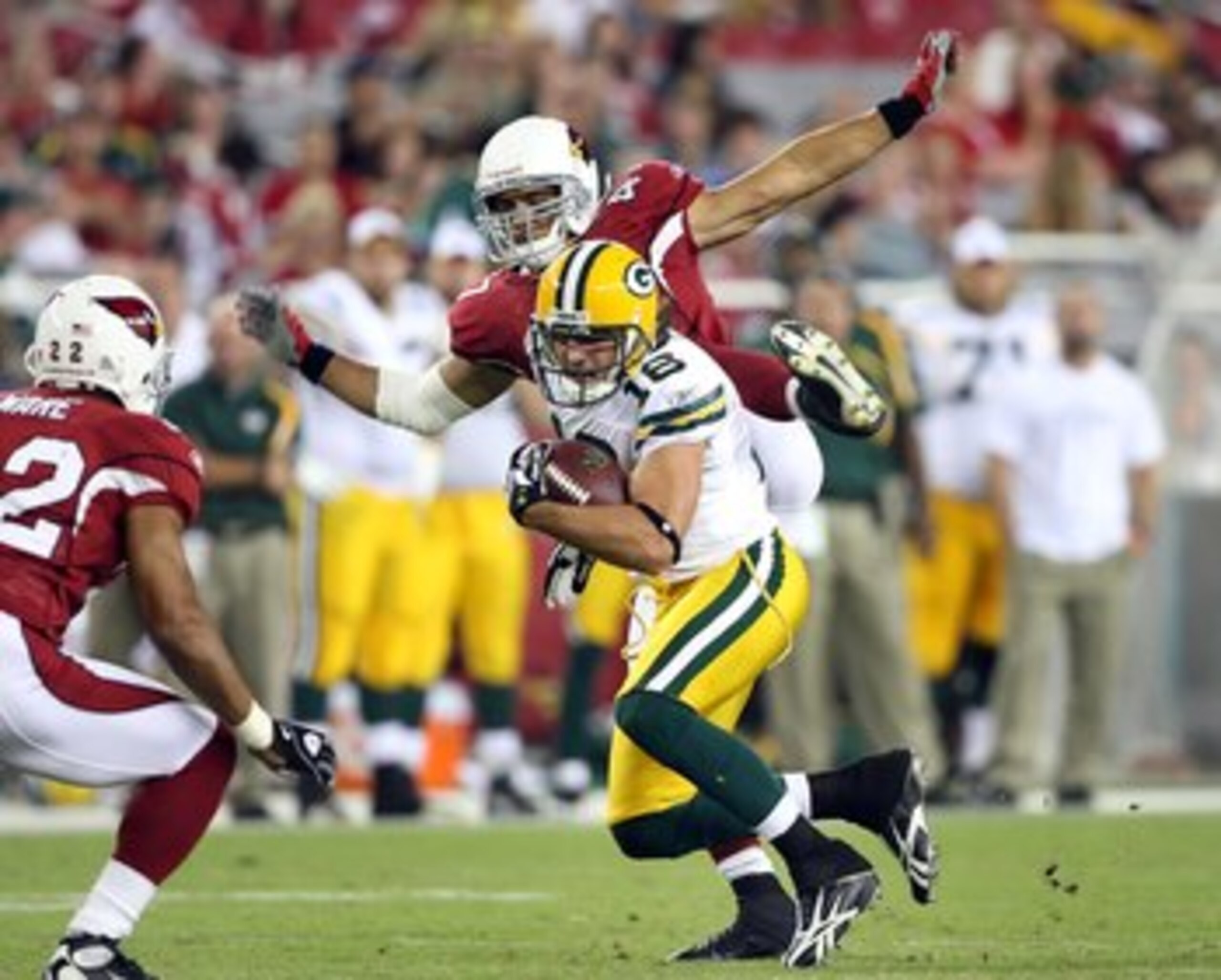 GLENDALE, AZ - AUGUST 28:  Wide receiver Brett Swain #26 of the Green Bay Packers runs with the ball after a reception past Rashad Johnson #41 of the Arizona Cardinals during the preseason NFL game at the Universtity of Phoenix Stadium on August 28, 2009